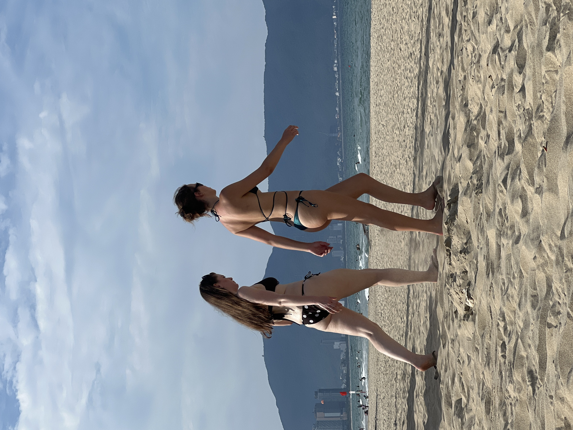Busy morning on Da Nang's beach with swimmers and shoreline walkers