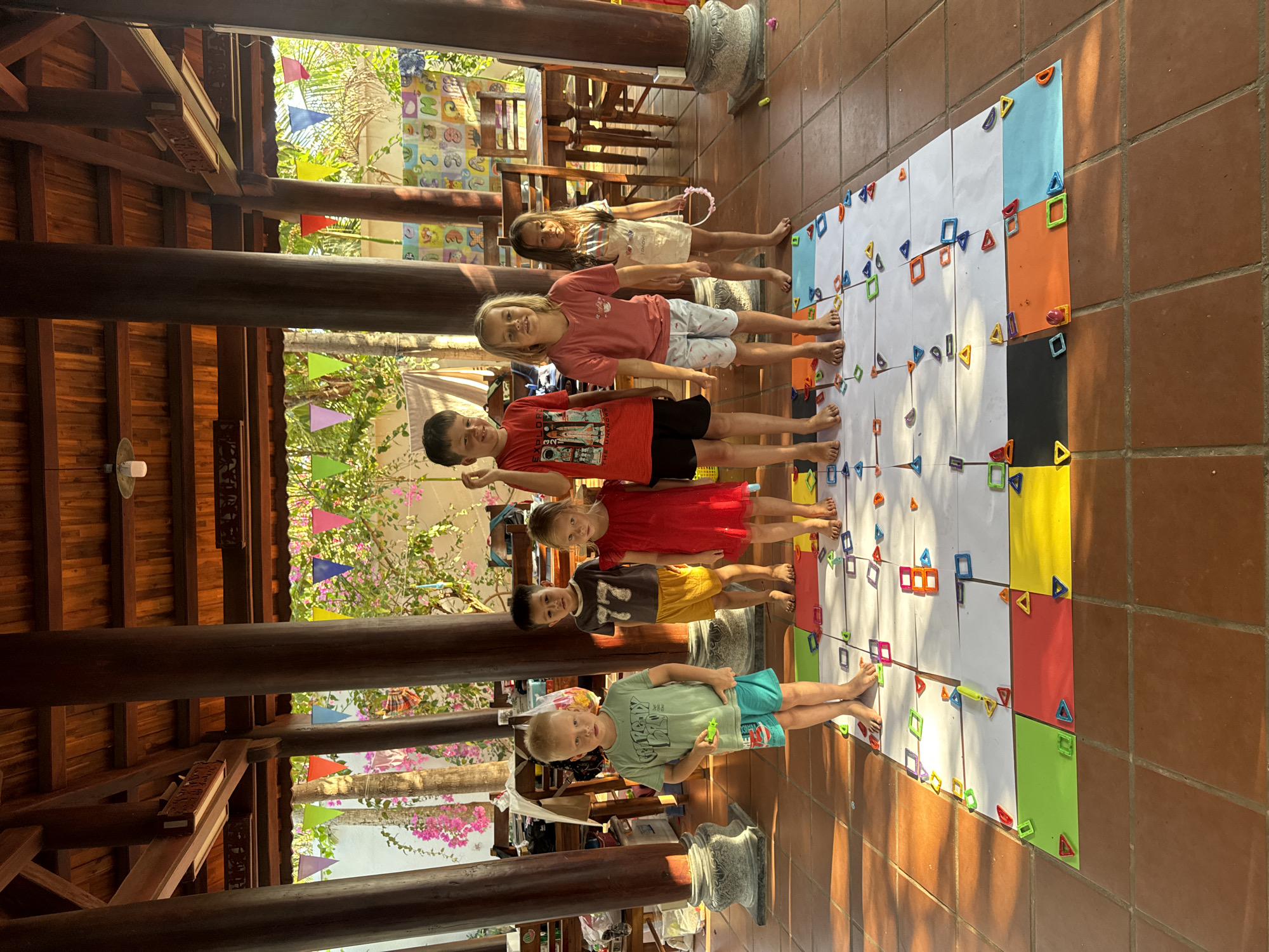 Children play floor game in Vietnamese pavilion