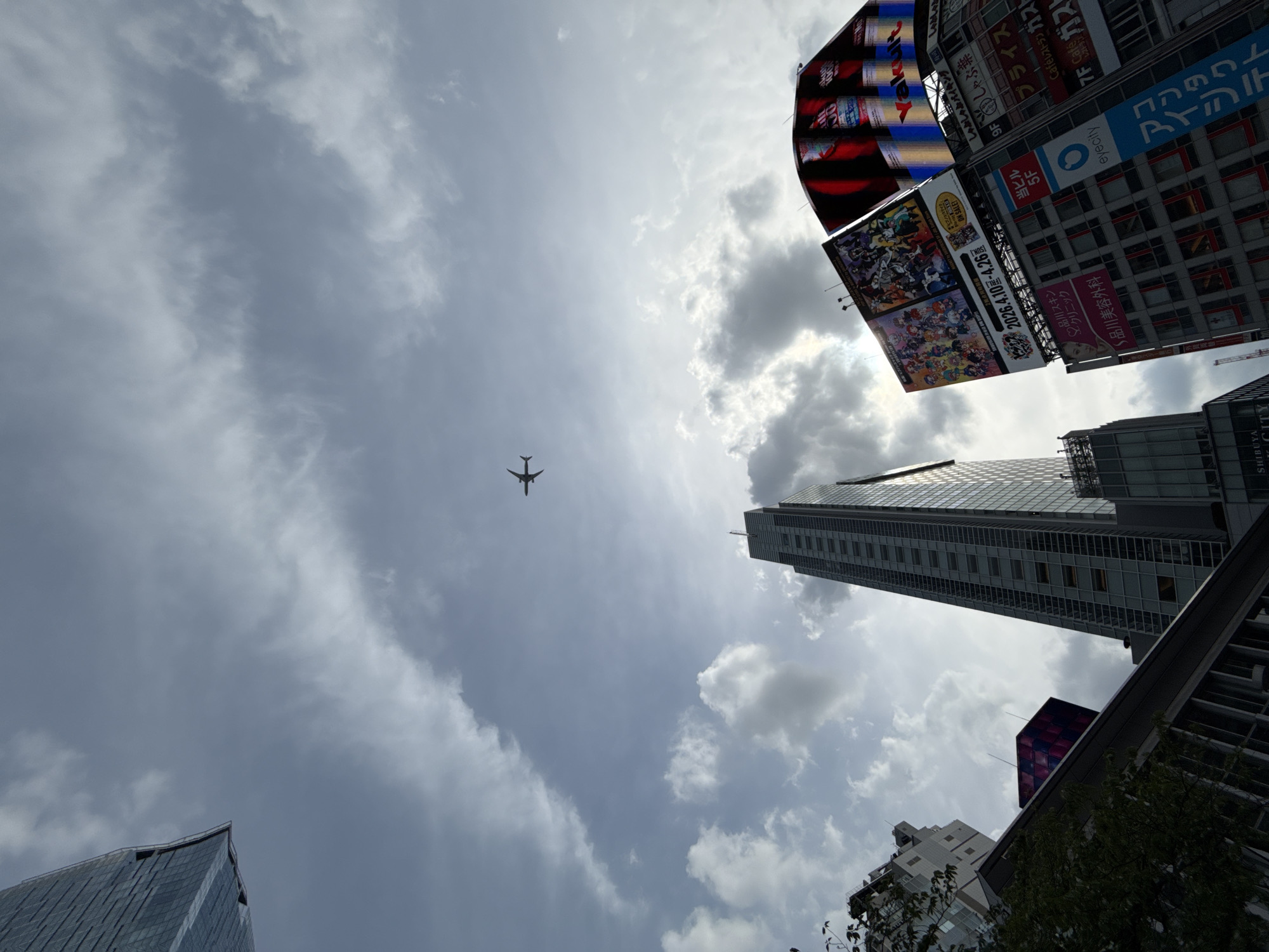Aircraft spotted over Shibuya skyline during morning hours