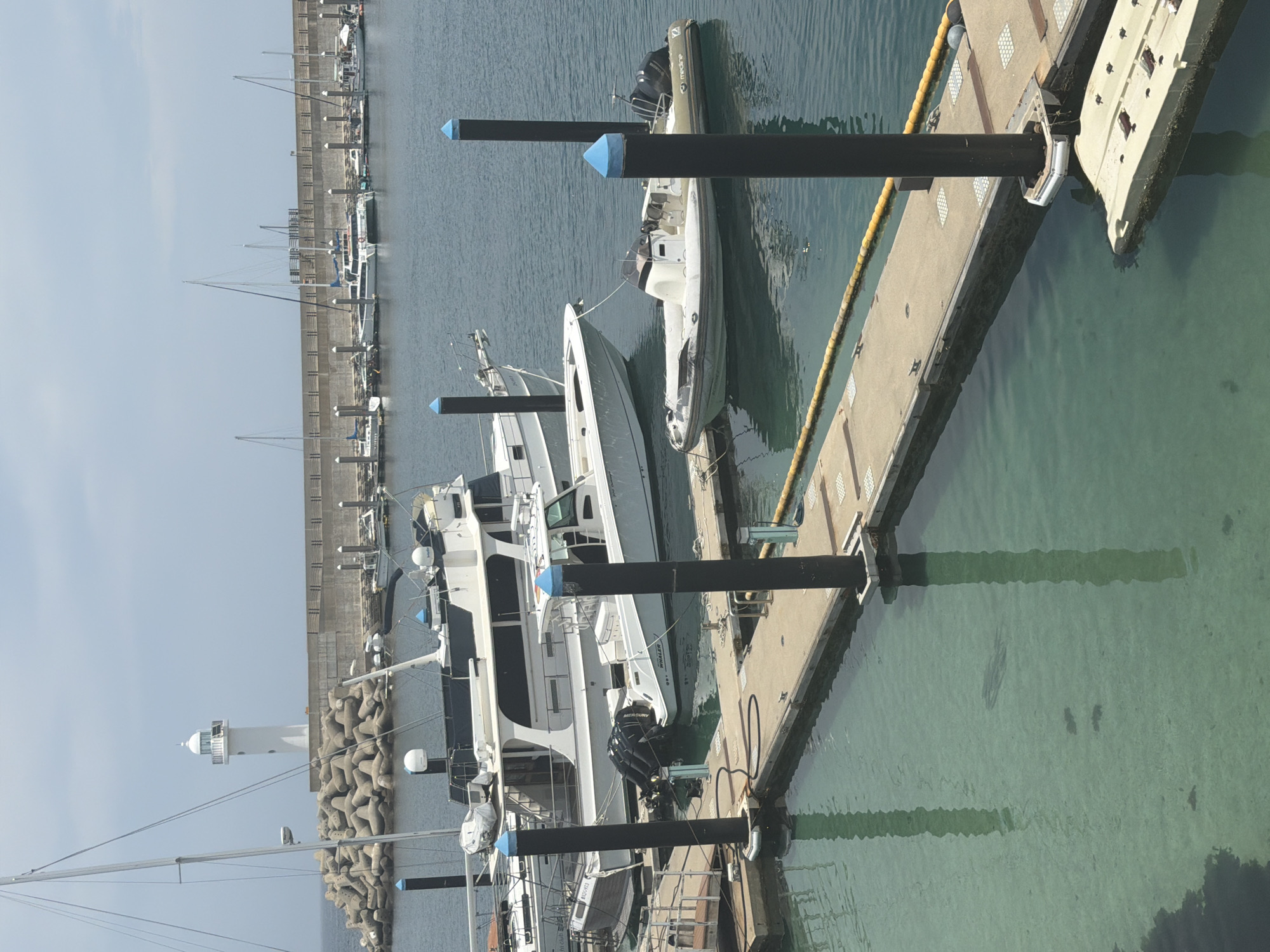 Jeju marina scene: boats, jet skis, and clear harbor water