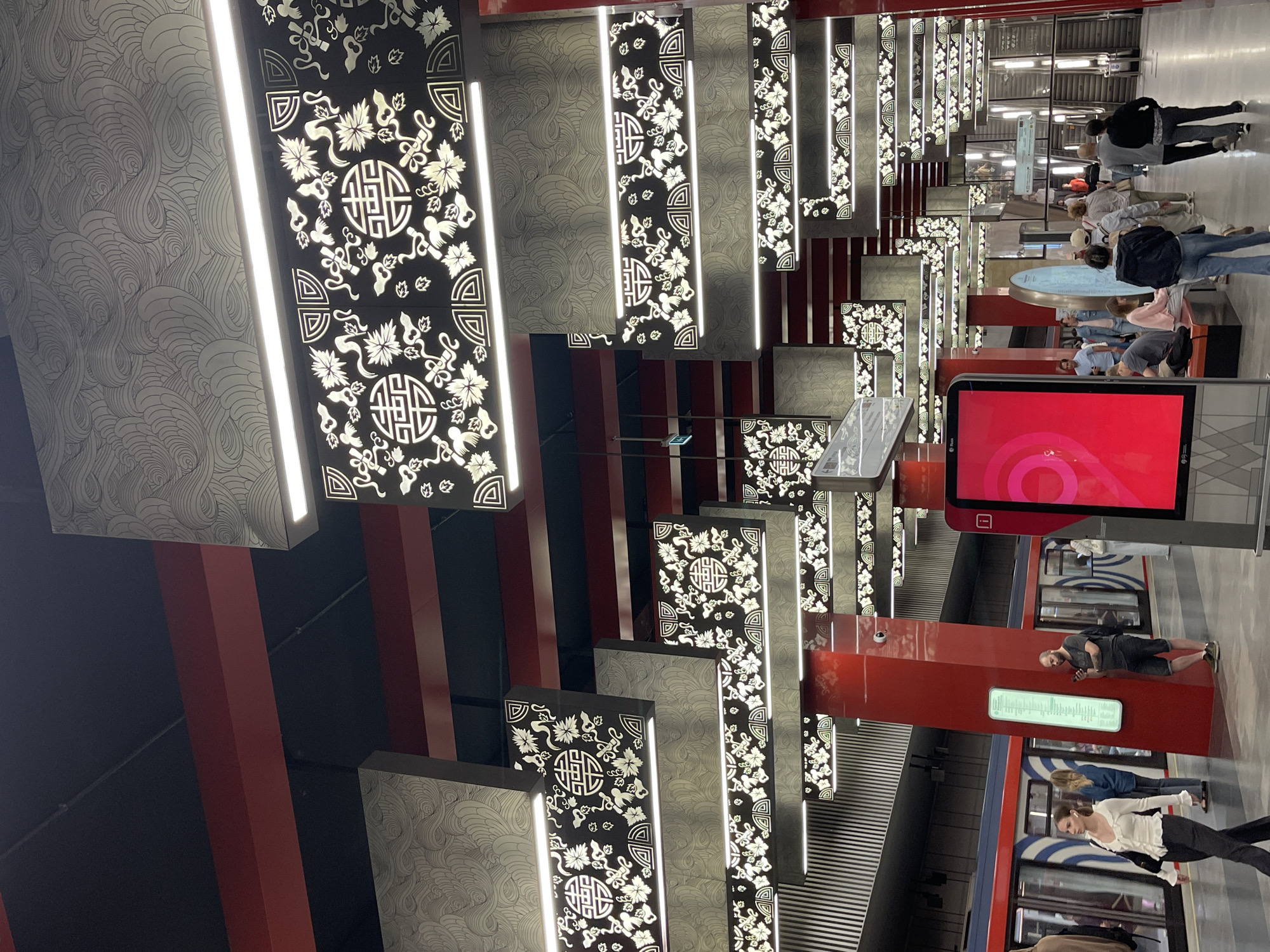 Inside a decorated subway station as a train arrives