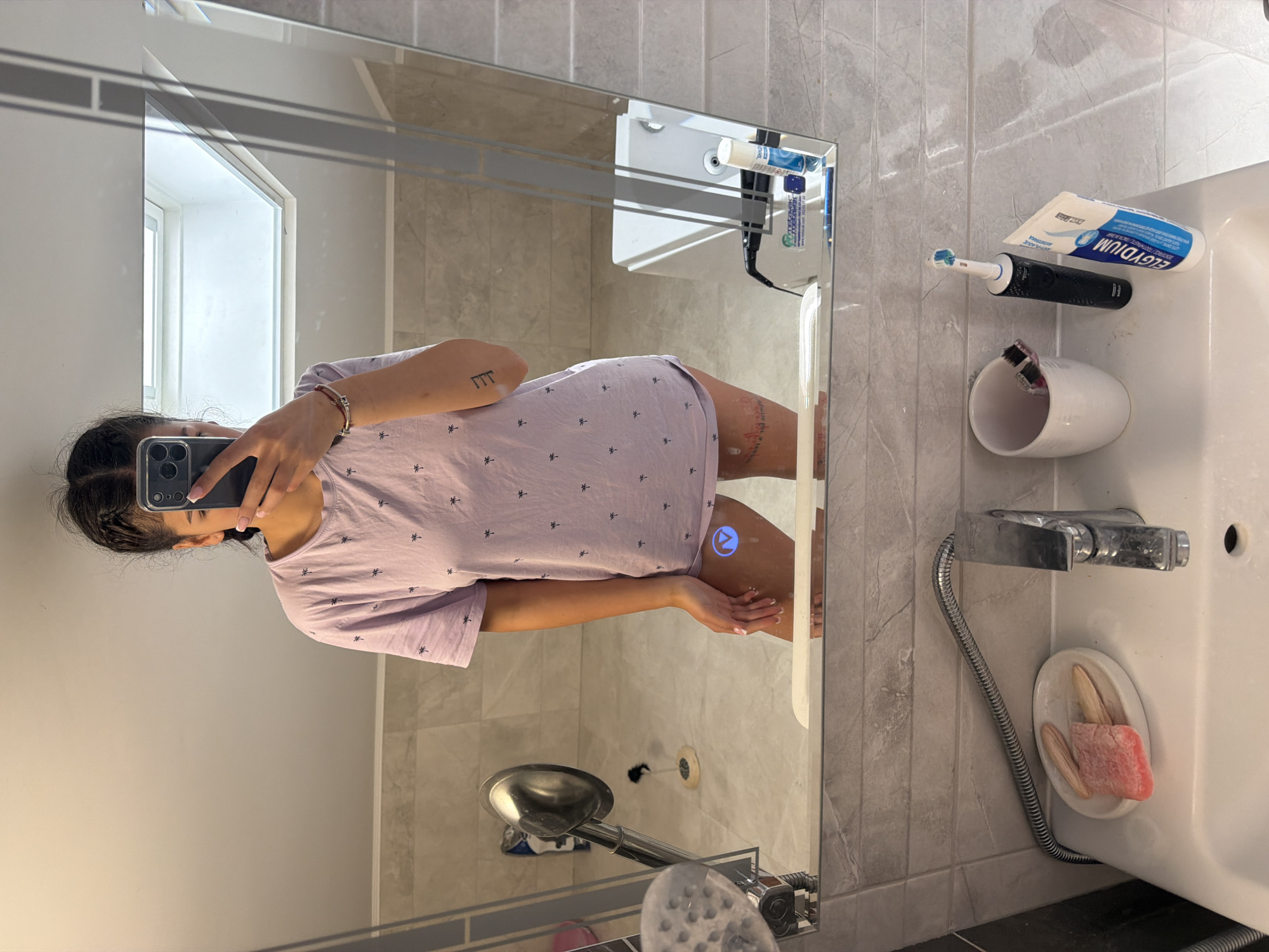 Woman takes bathroom mirror selfie in Gabrovo, Bulgaria