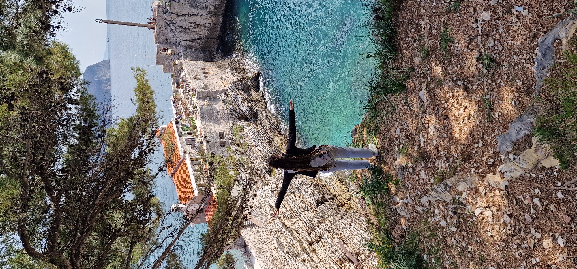 Visitors explore scenic coastal cliffs and fortress in Montenegro