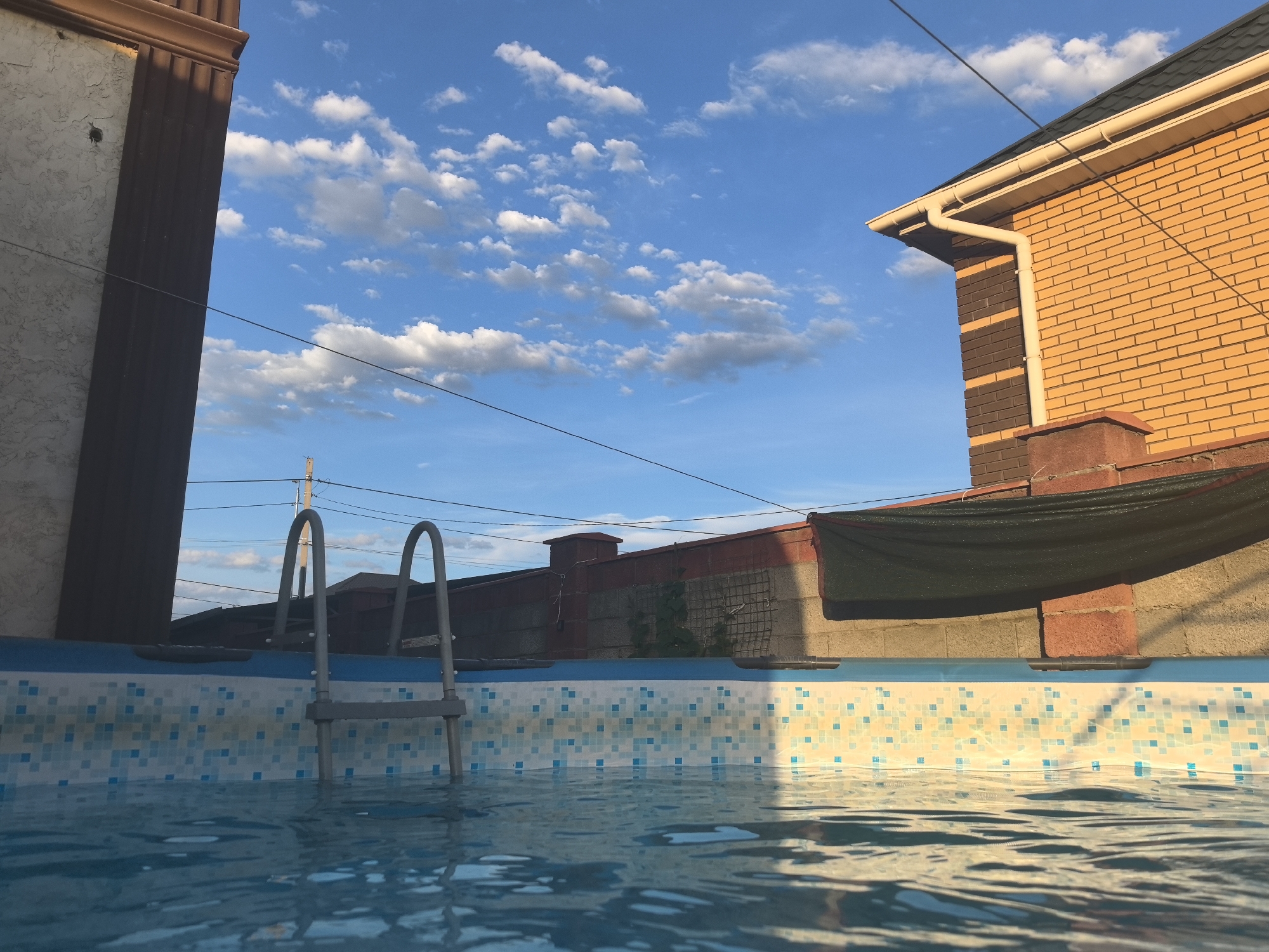 Taldykorgan backyard afternoon: poolside calm into stormy sunset
