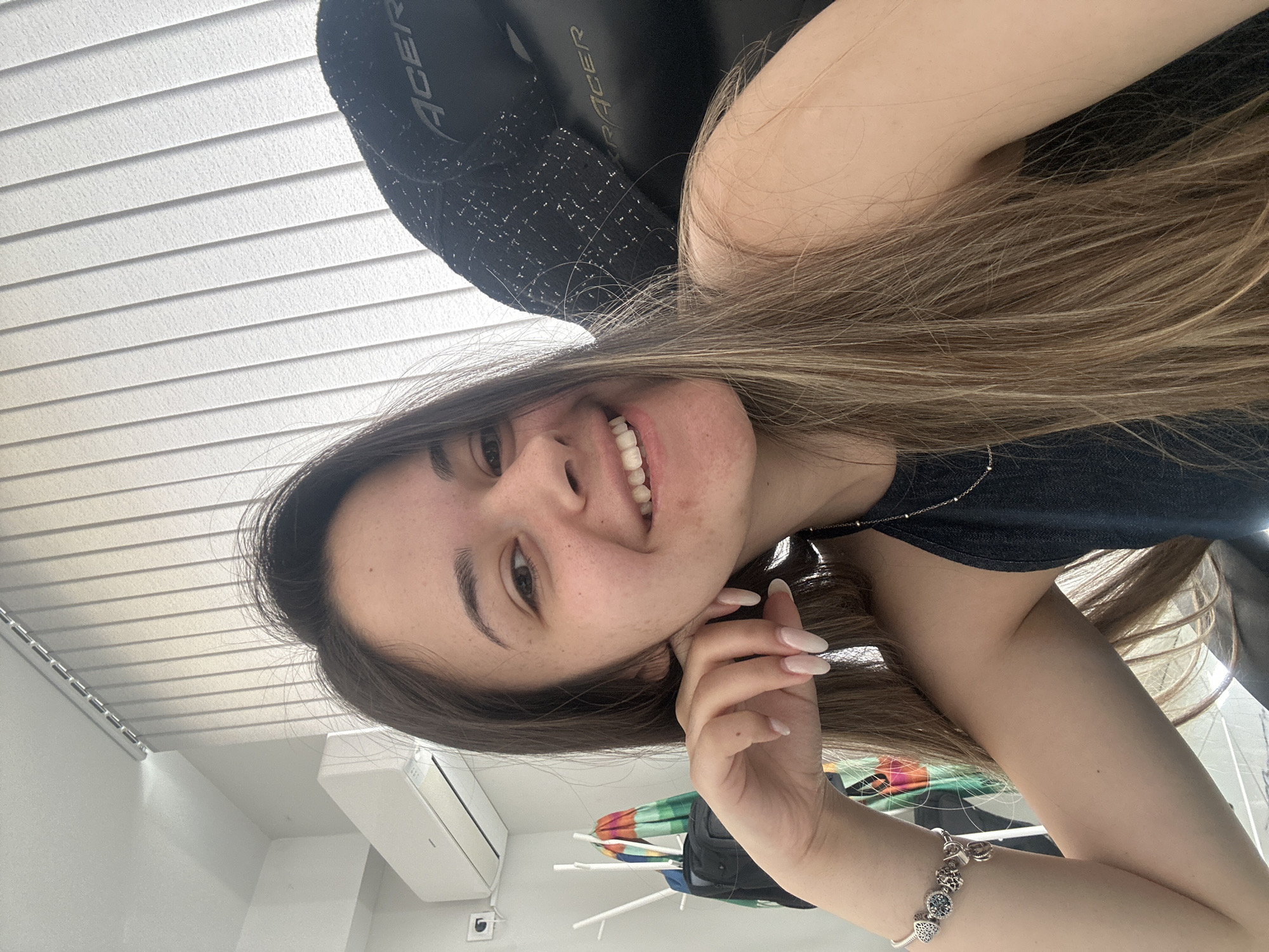 Woman takes multiple selfies in gaming chair in Sofia
