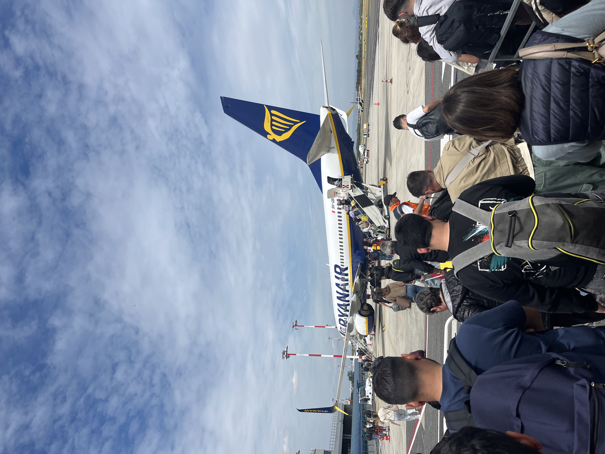 Ryanair passengers board crowded Rome flight, depart over snowy terrain
