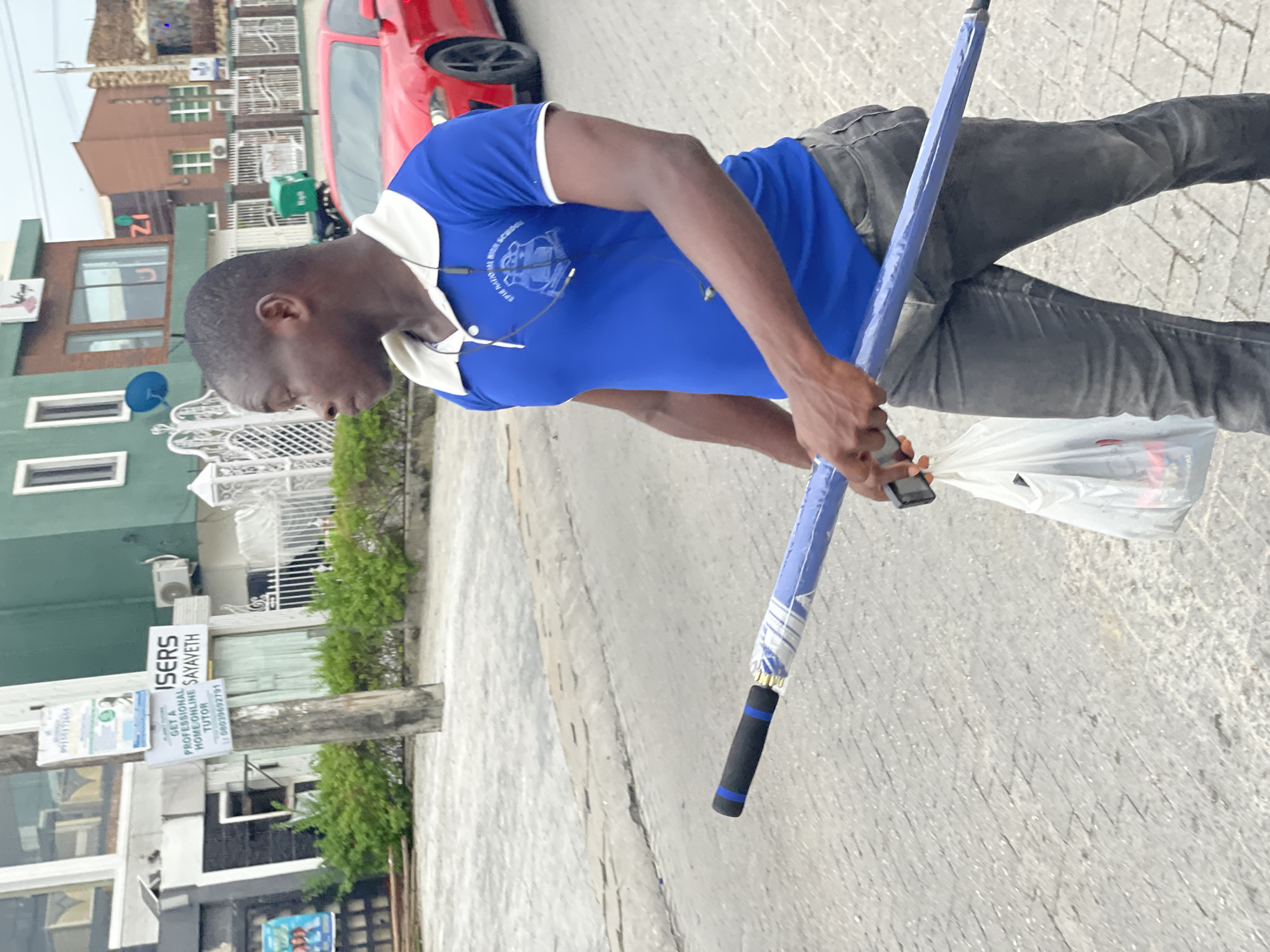 Afternoon street life in Moba, Nigeria during overcast weather