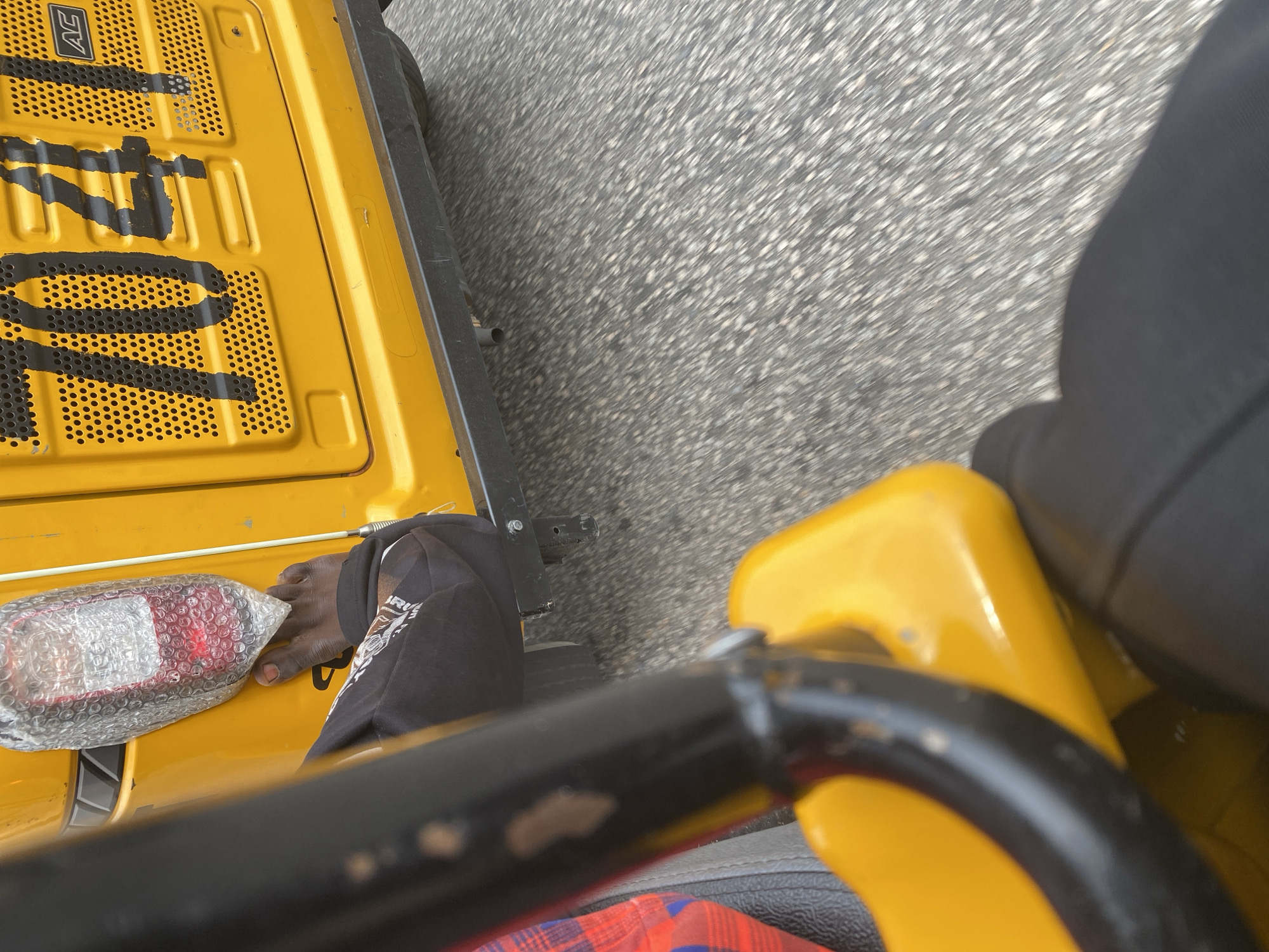Riding through Jalingo streets in a yellow Keke Napep