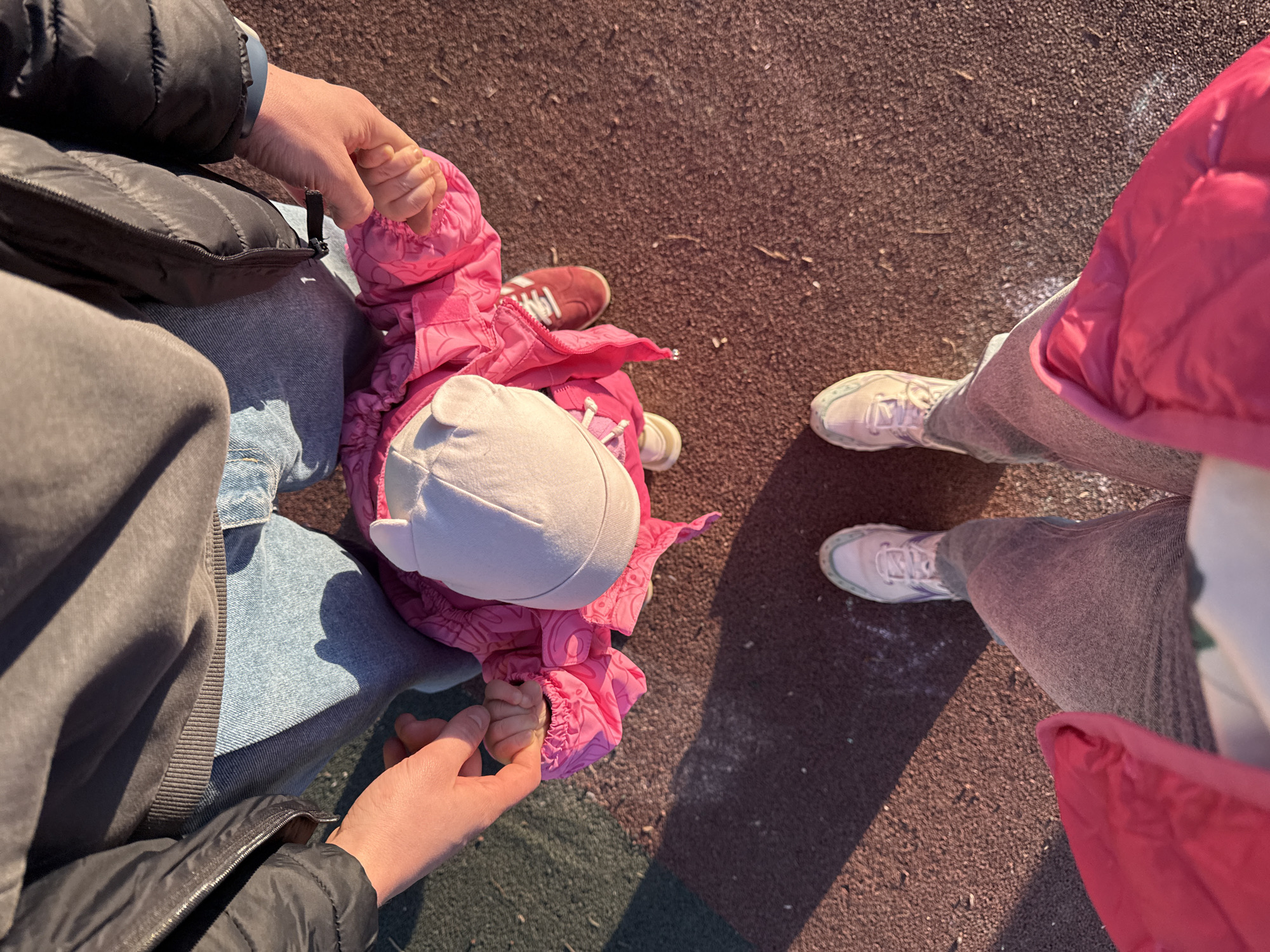 Family enjoys playground time with toddler in Moscow