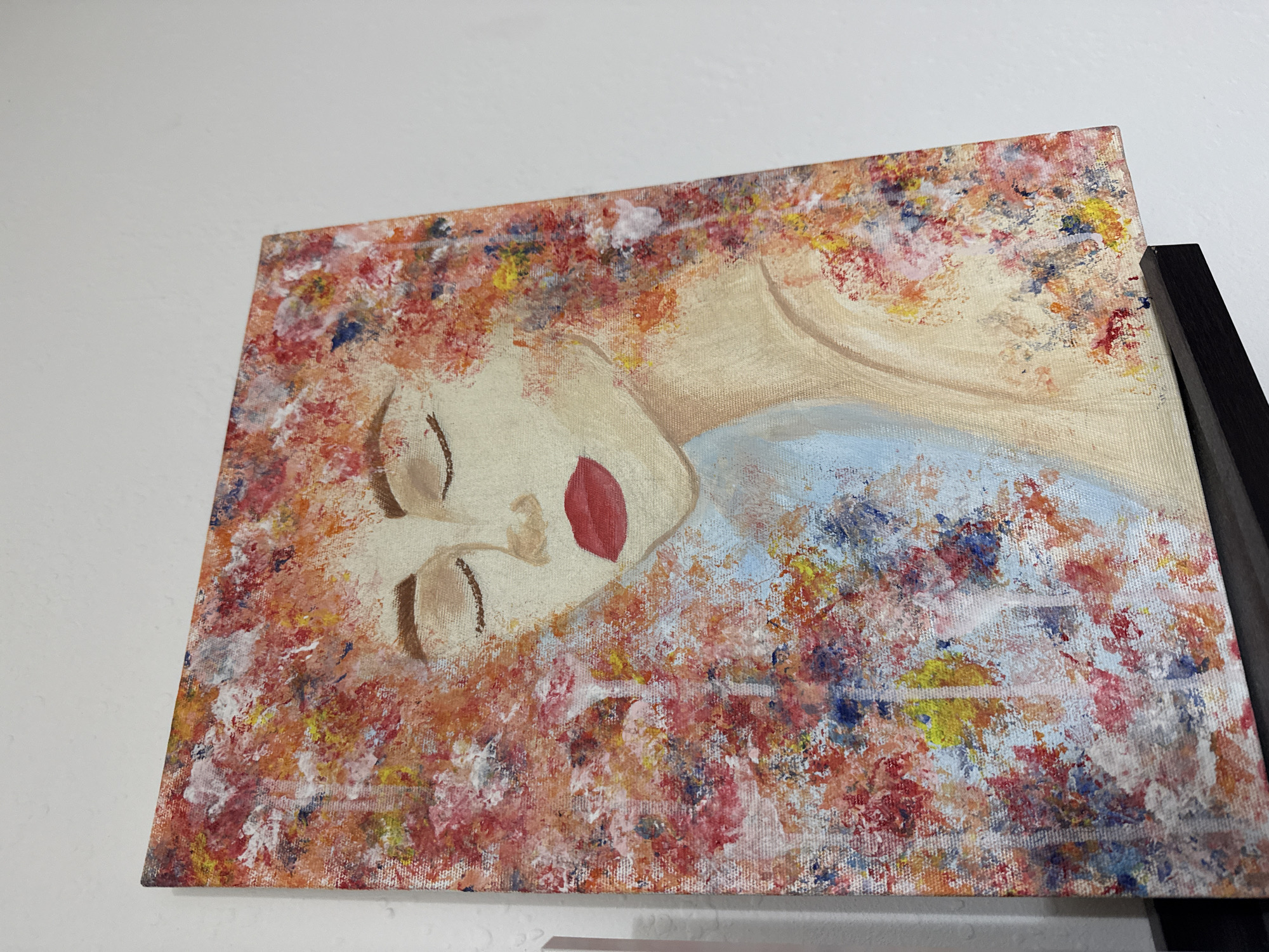 Painting of reclining blonde woman observed in Burgas, Bulgaria