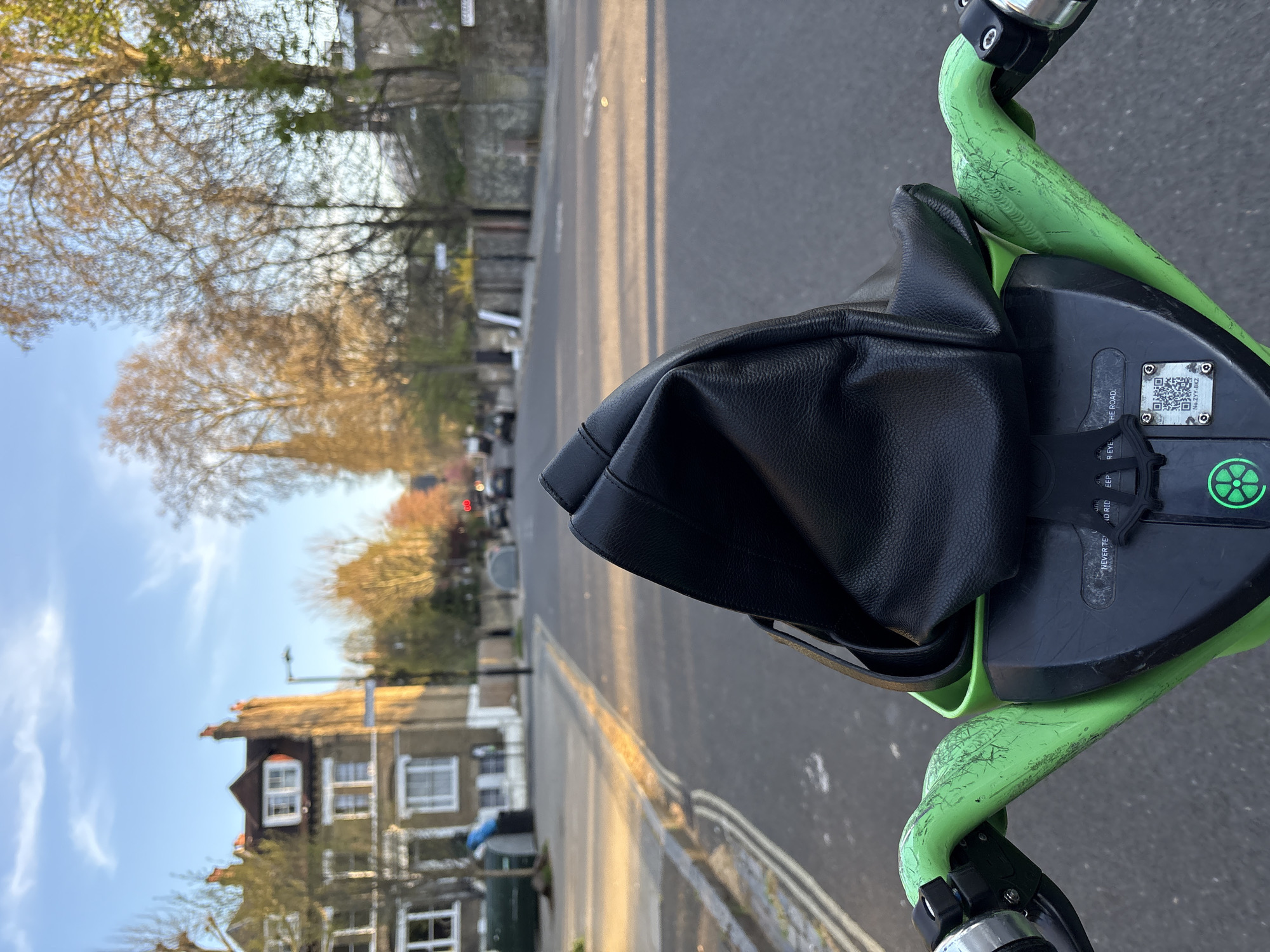 Lime scooter rider navigates London street with bag obstruction