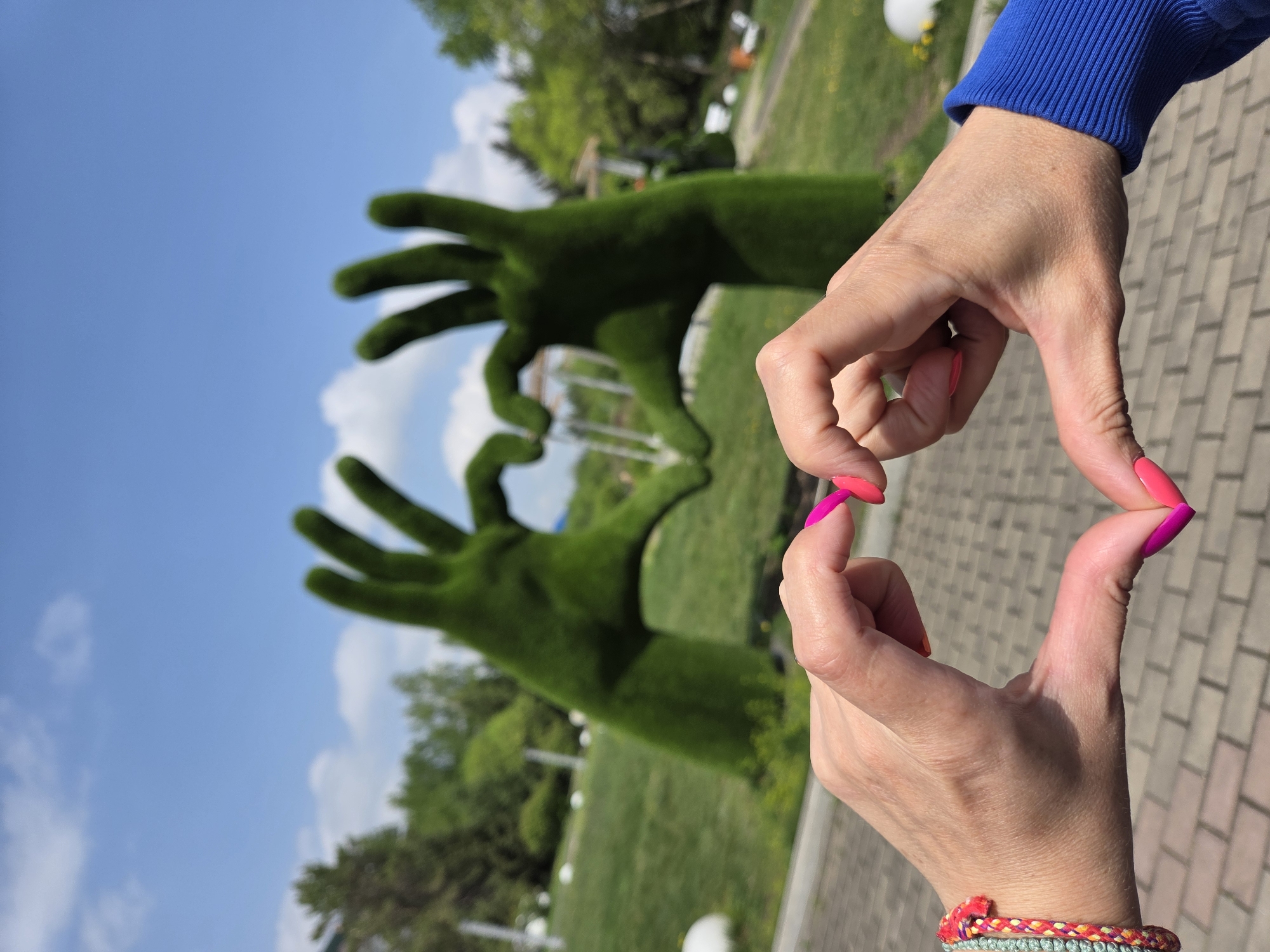 Woman makes heart gestures in Birobidzhan park early morning