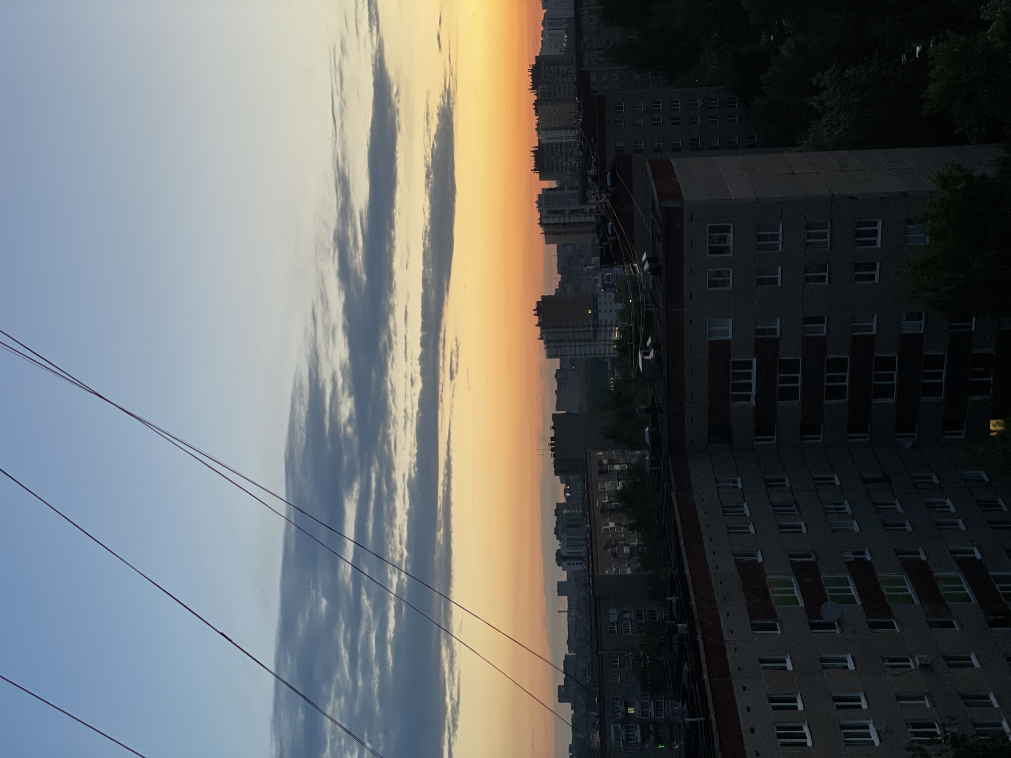 Vibrant sunset colors illuminate Izhevsk cityscape at twilight