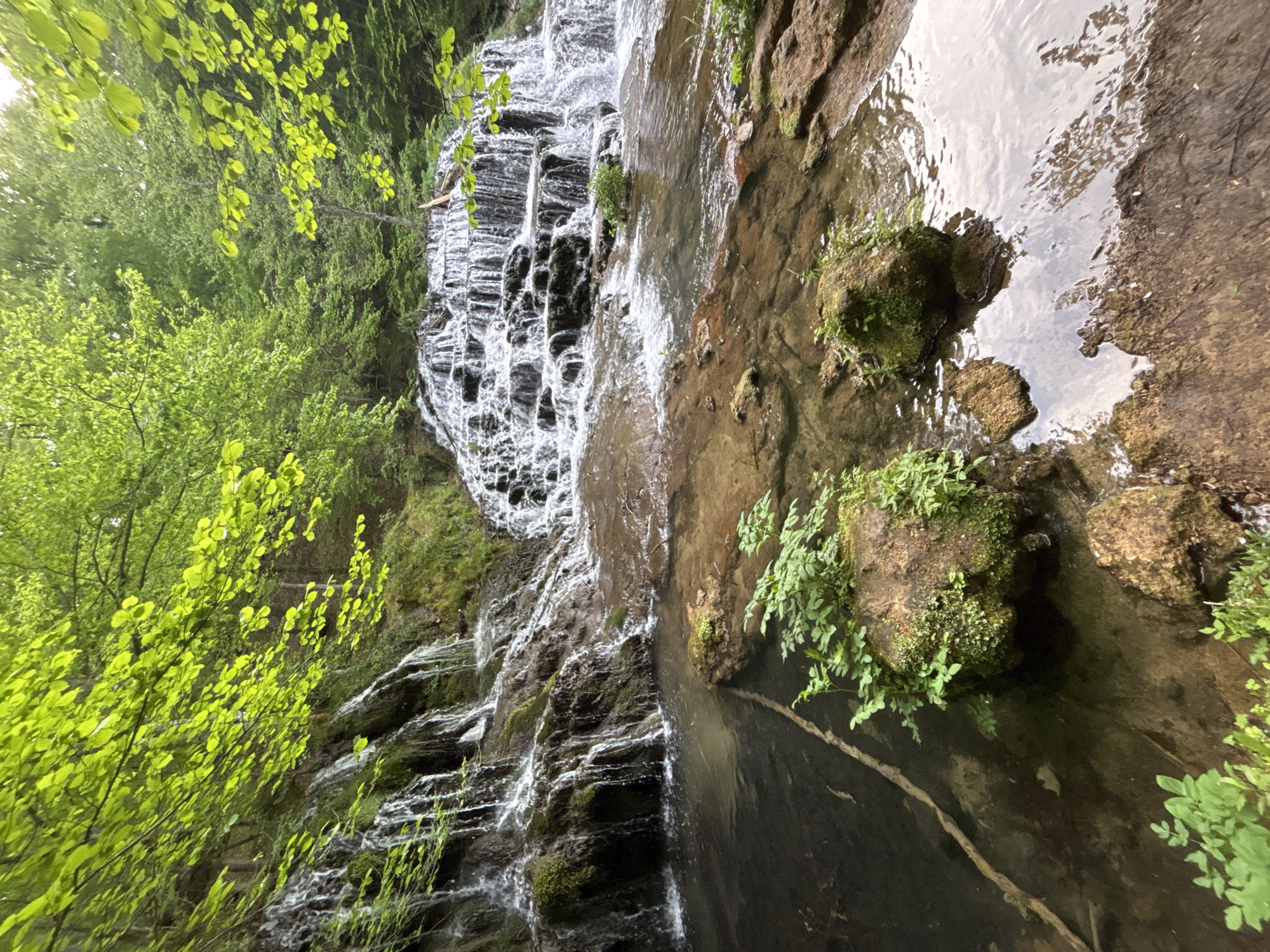 Waterfall flows over mossy rocks in Stoilovo, Bulgaria