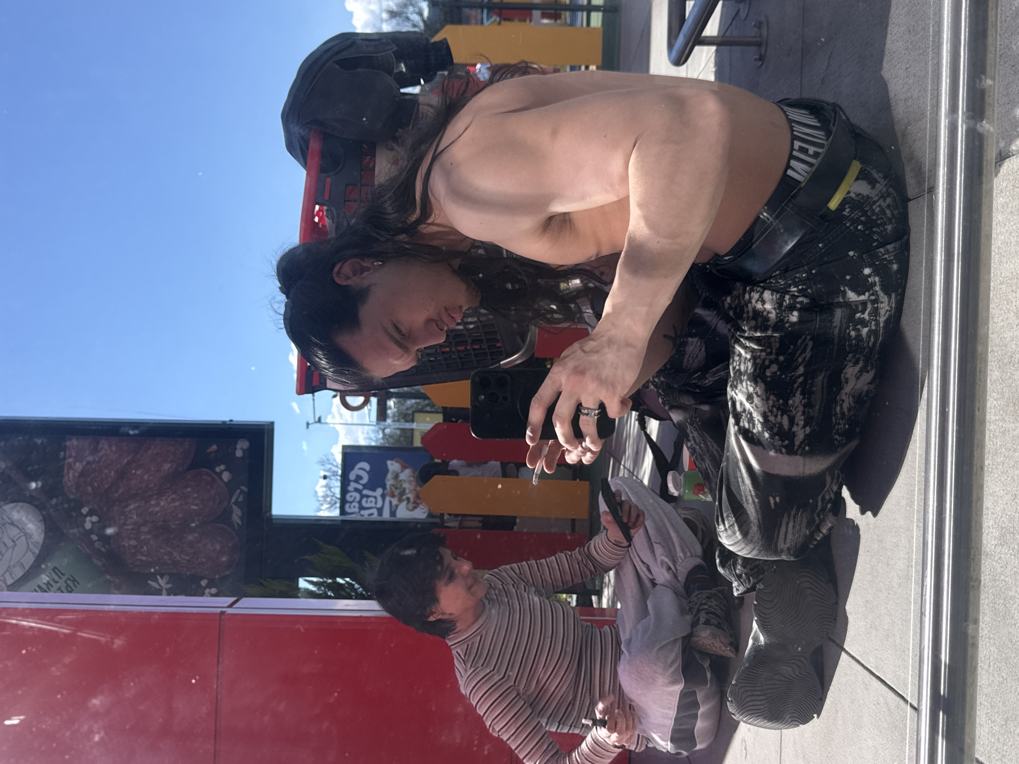 Person photographed smoking, using phone in Sofia