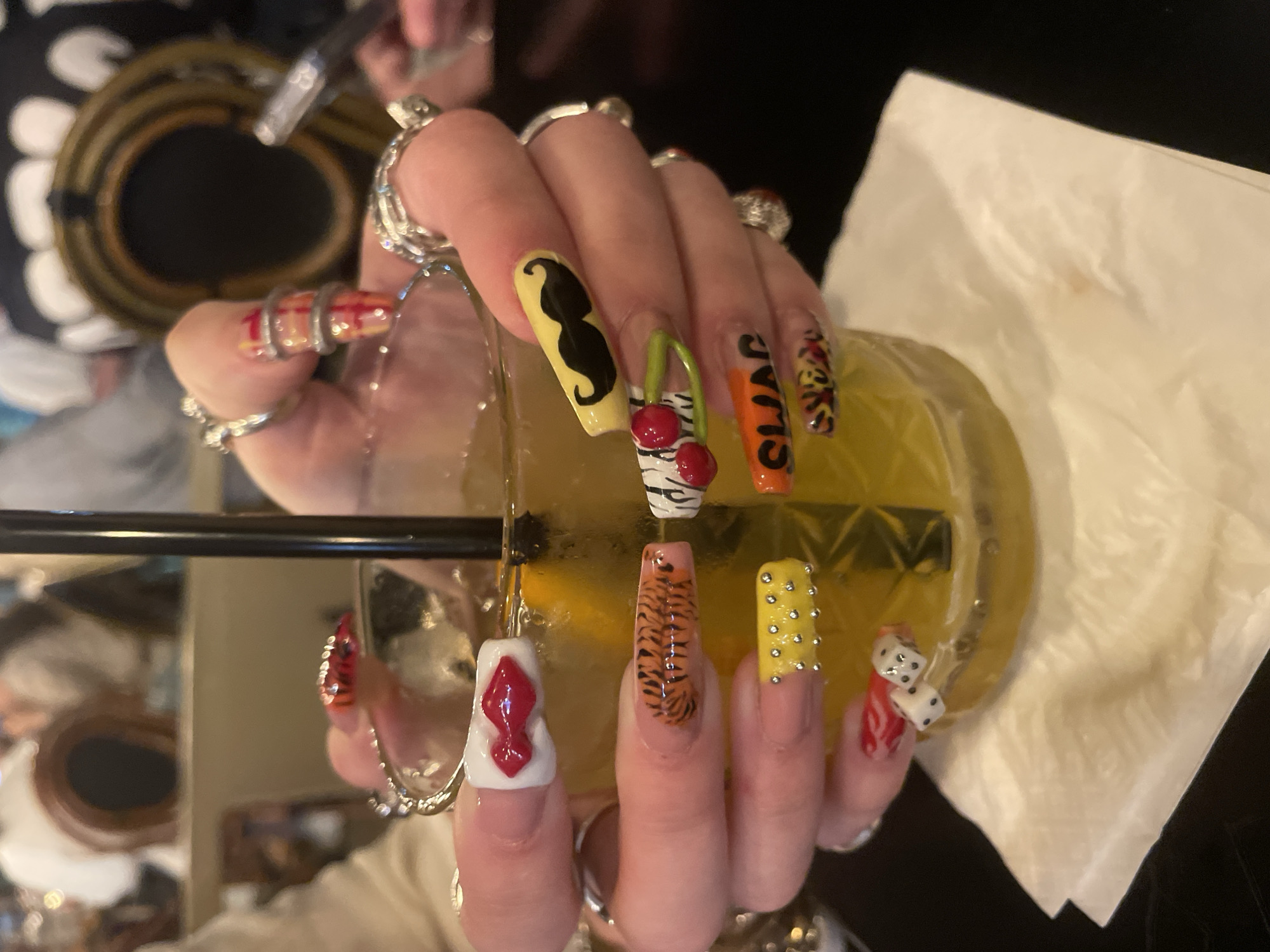 Woman shows off mustache nail art at Raanana restaurant