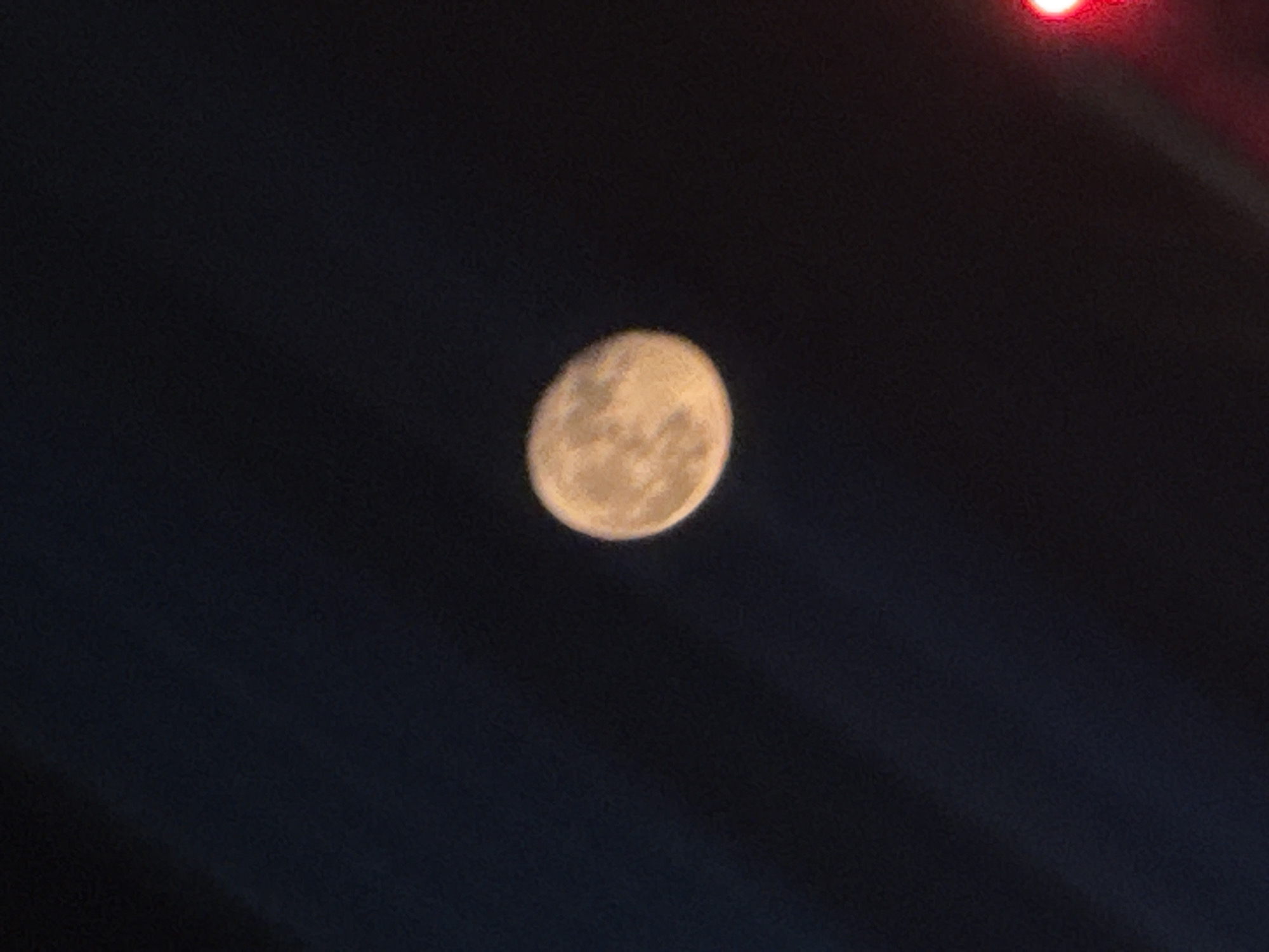 Moon photographed with red light in Moscow evening sky
