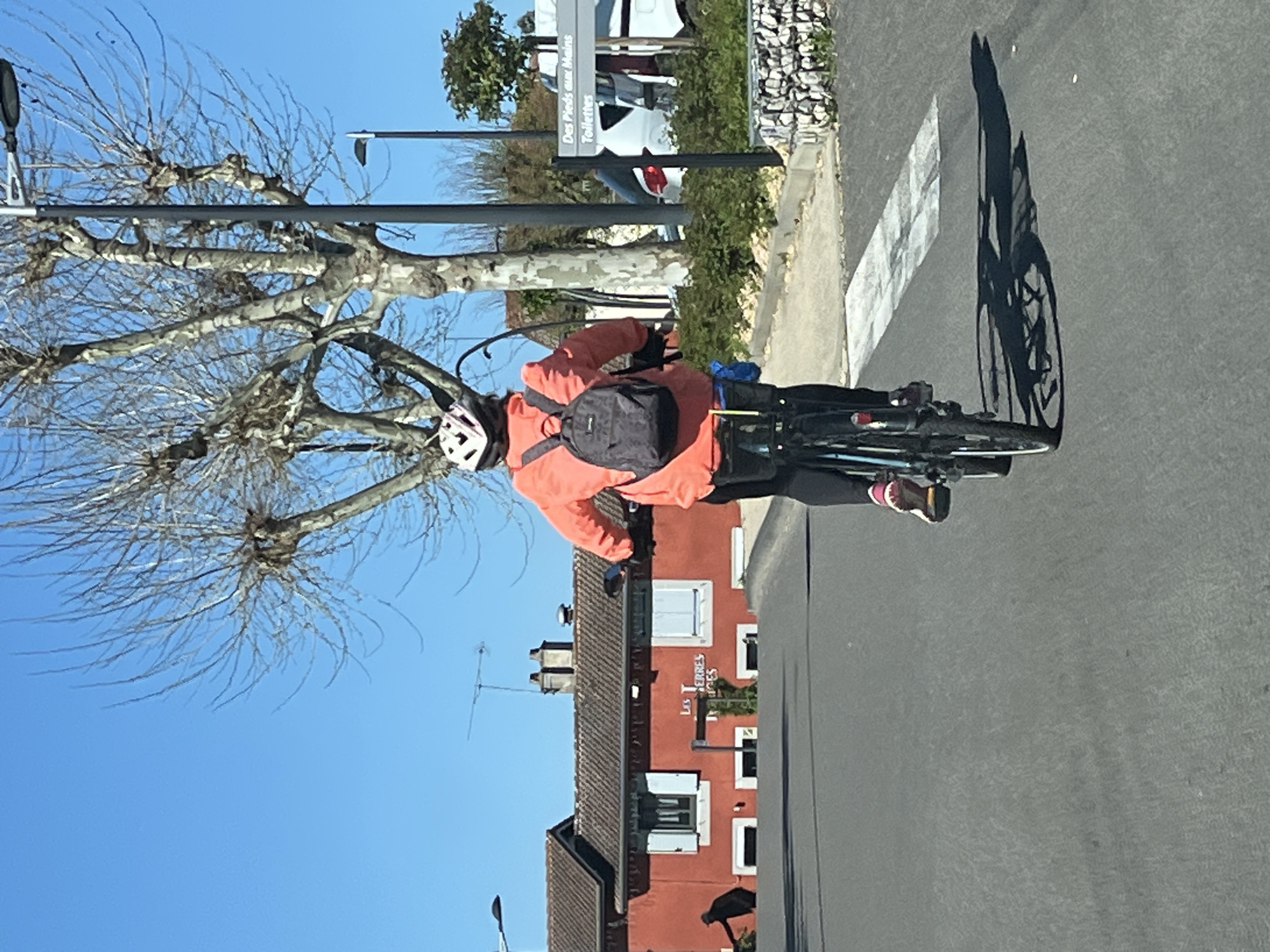 Cyclist spotted riding through Chambœuf, France wearing orange jacket