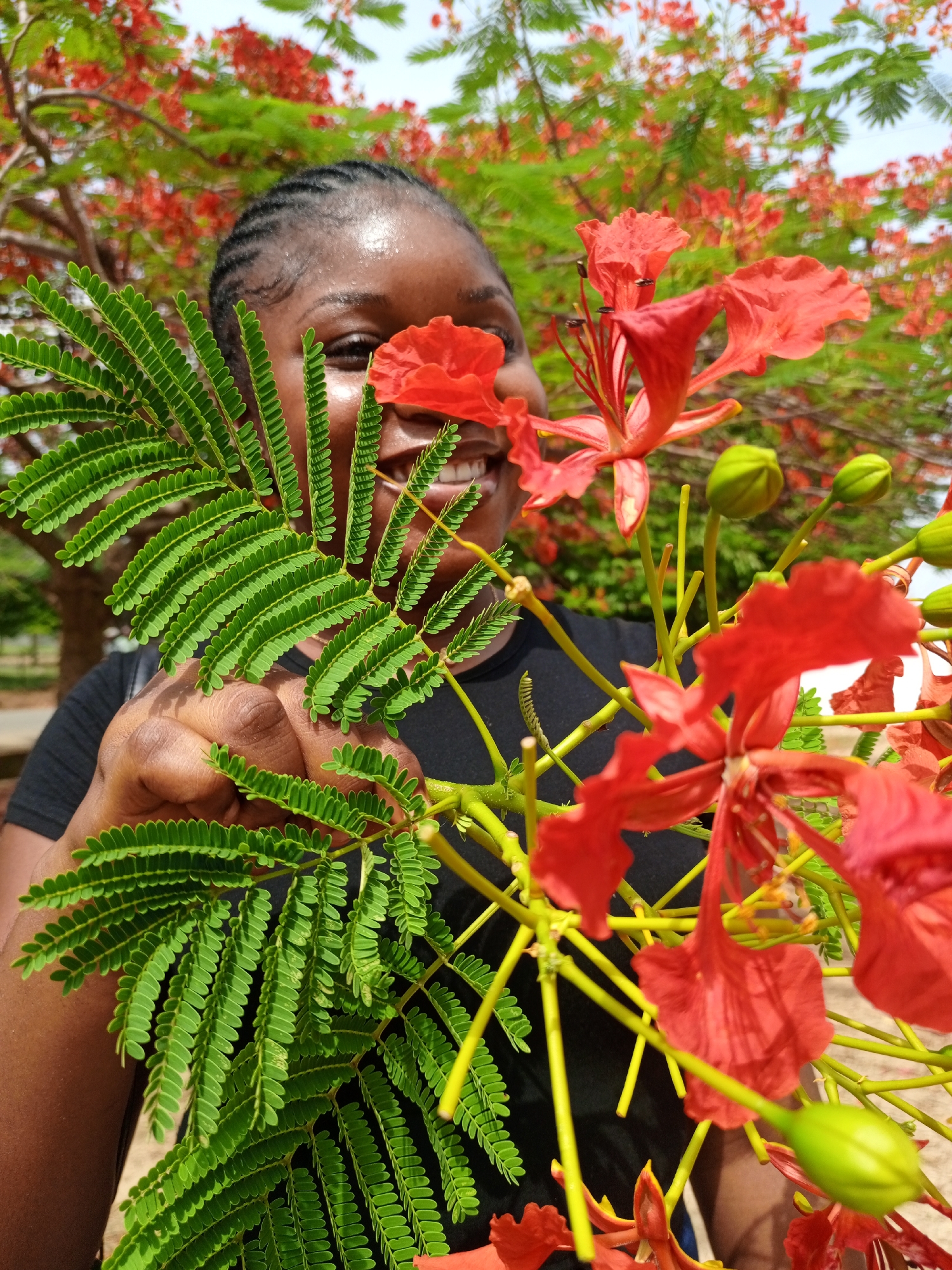 NSUK student photographed with flowers in Keffi outdoor setting
