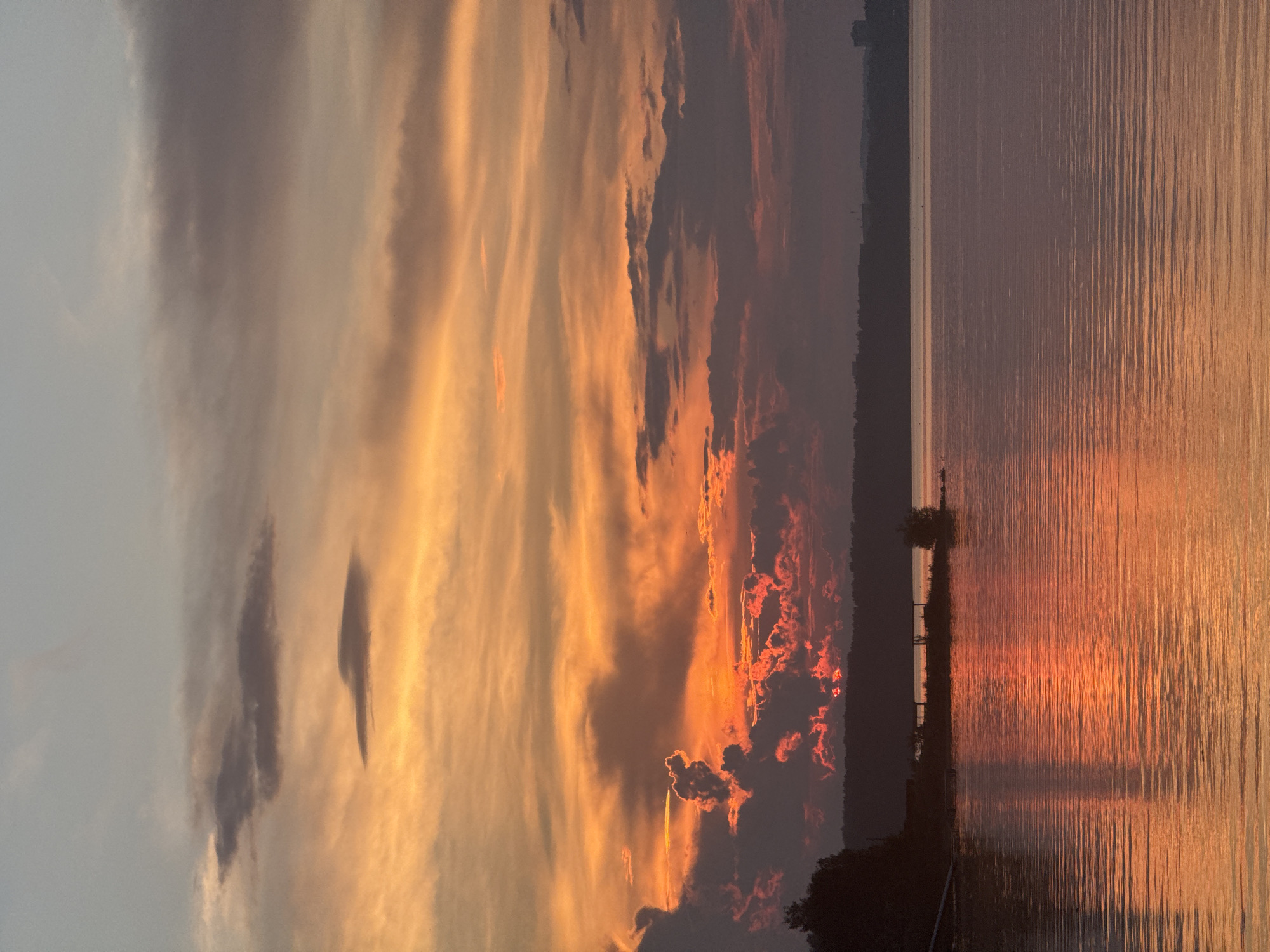 Lakeside campfire gathering during sunset on Kama River