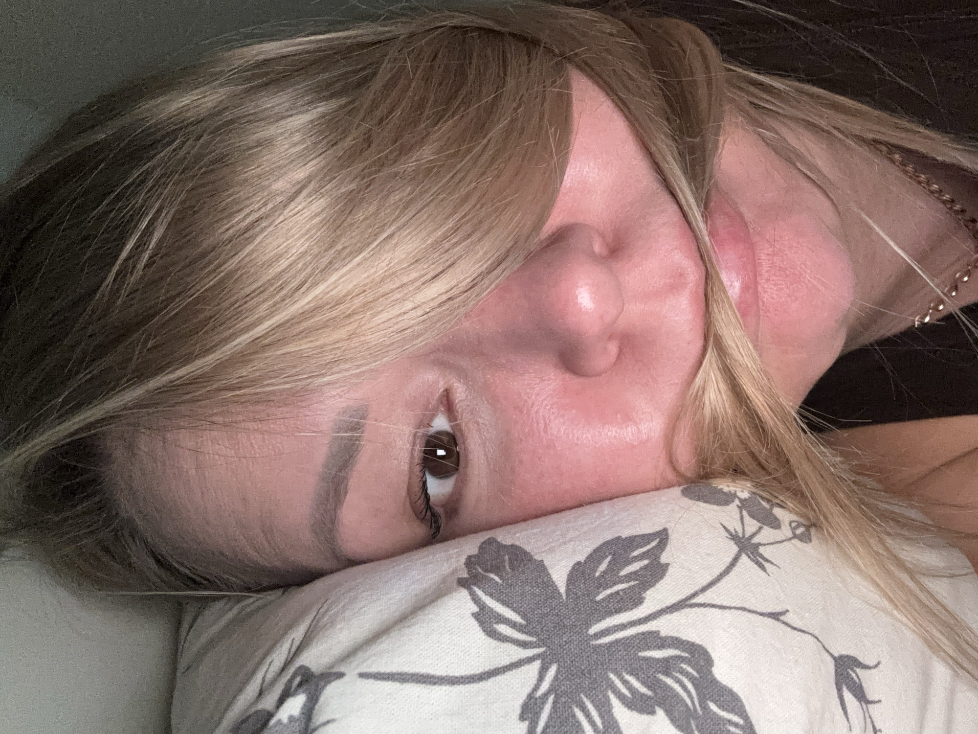 Woman rests on floral pillow in Izhevsk apartment