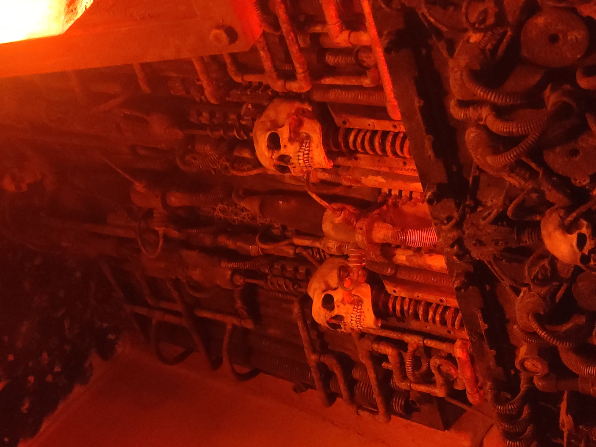 Industrial horror display with metal skulls and illuminated signage