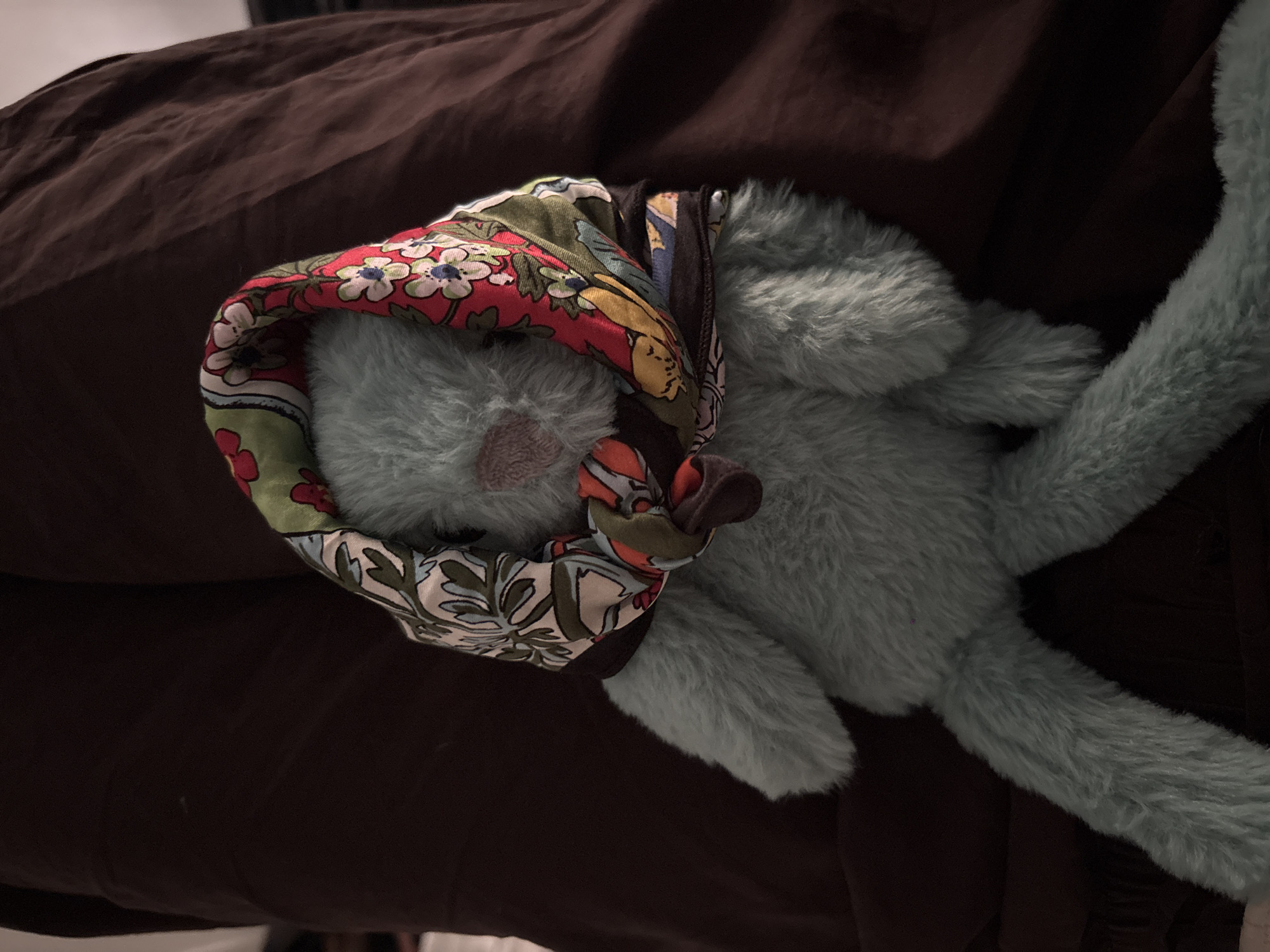 Blue stuffed rabbit spotted resting on fabric surface in Milan