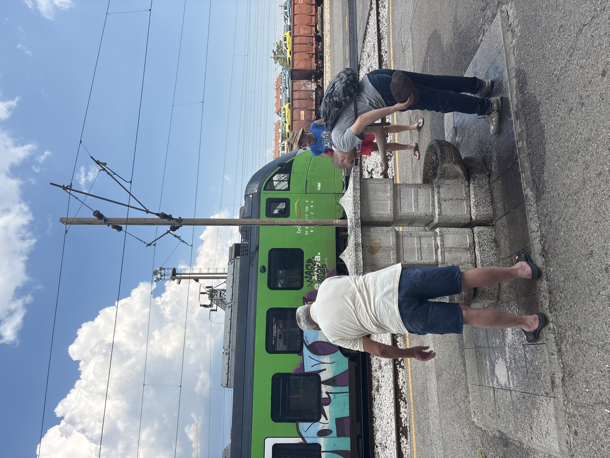 Afternoon at Podgorica train station, trains and travelers in the sun