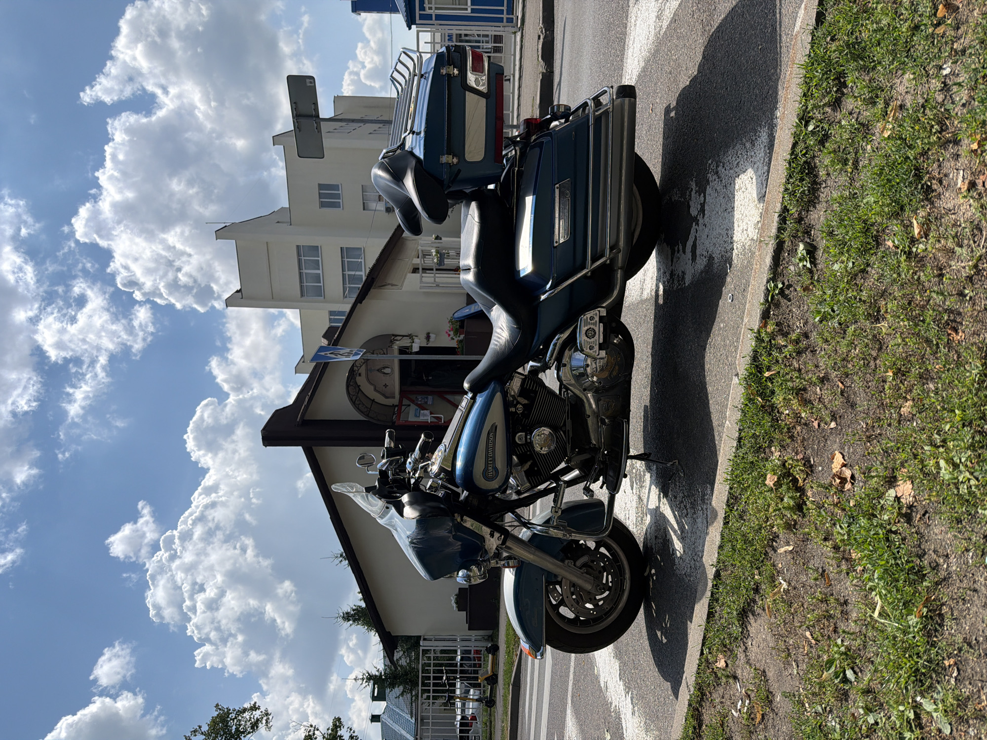 Harley parked, cyclists rolling — a quiet Minsk street corner