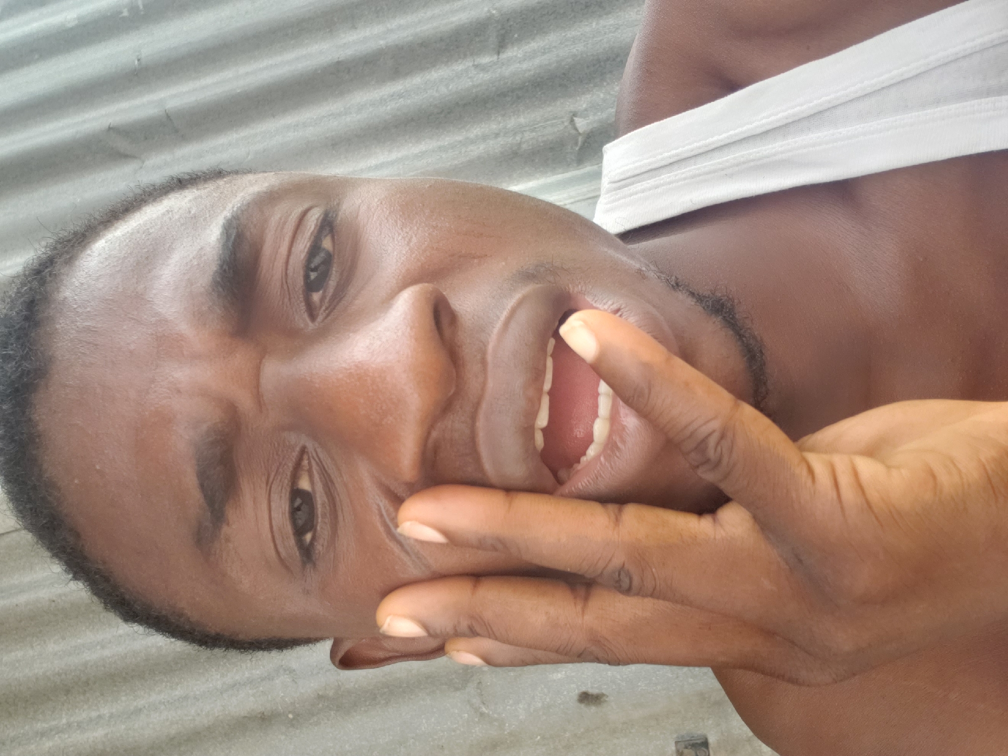 Man poses for multiple photos on Adankolo streets