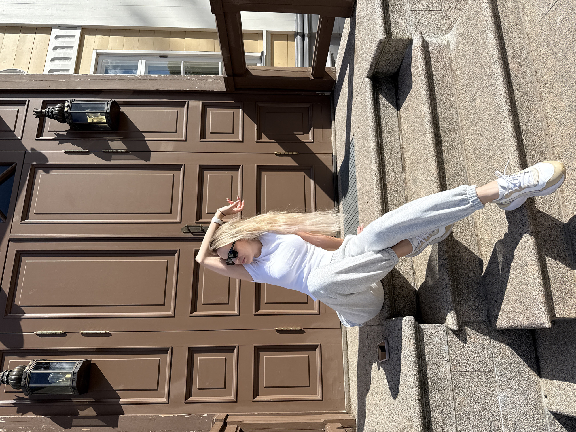 Women pose for photos on historic building steps in Vyborg