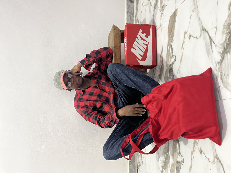 Person conducts photo session with various outfits in Ghana