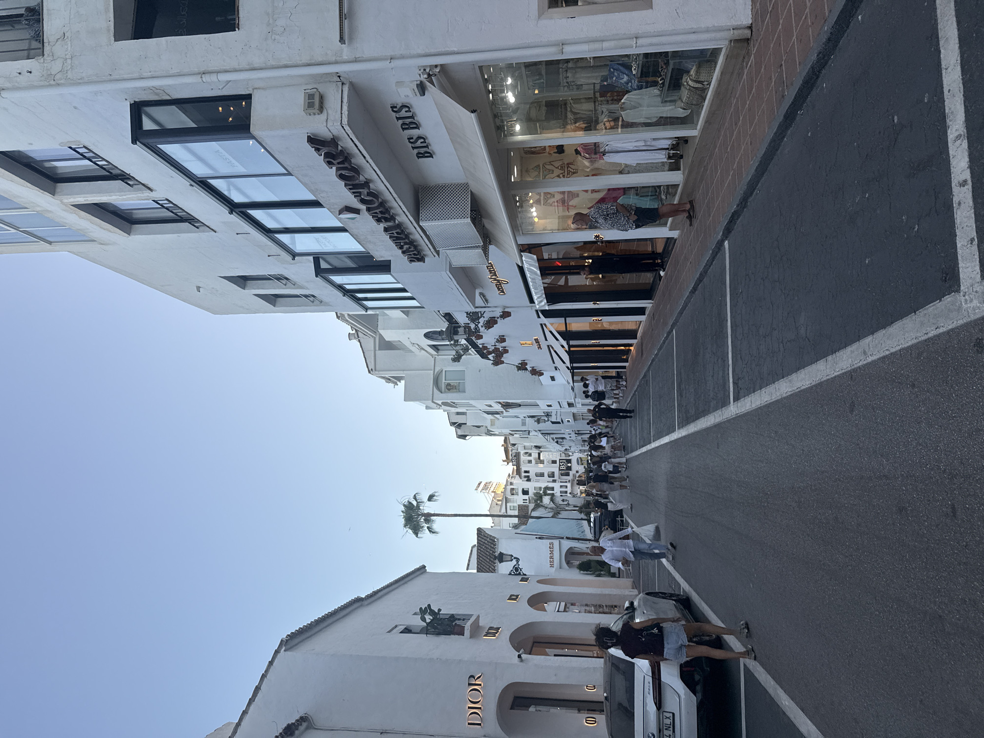 Luxury cars and designer boutiques fill Marbella's golden-hour streets