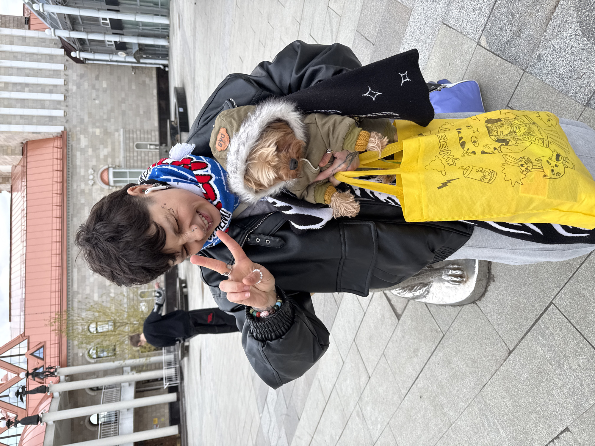 Person with dogs photographed in city square area