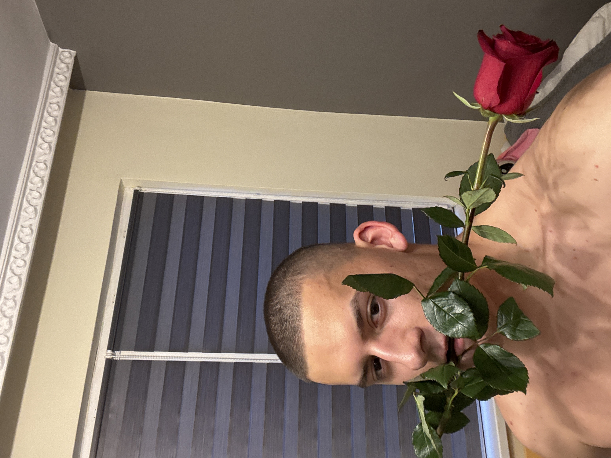 Man poses with flowers indoors in Burgas, Bulgaria