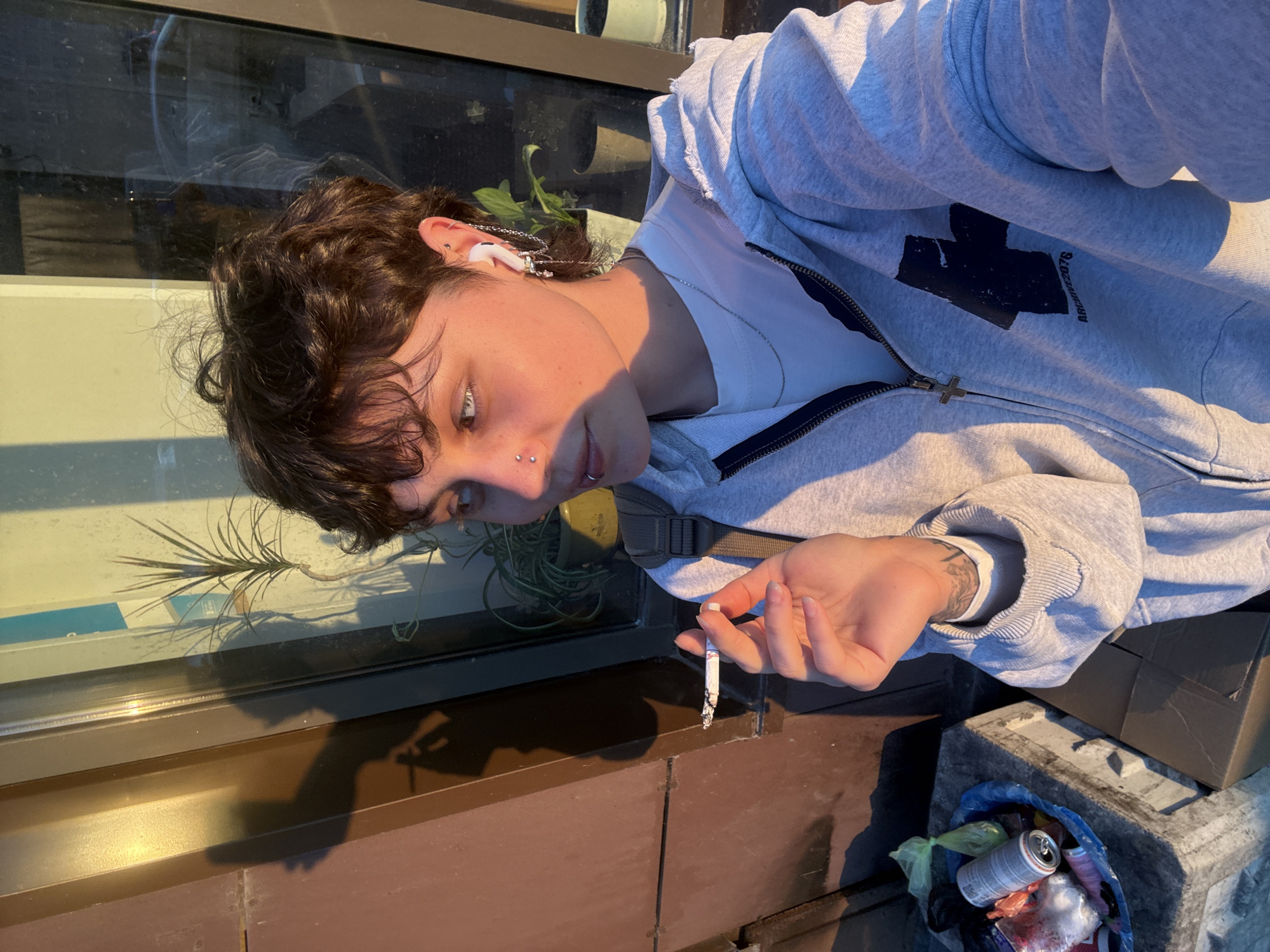 Person takes smoking selfie during golden hour in Saint Petersburg