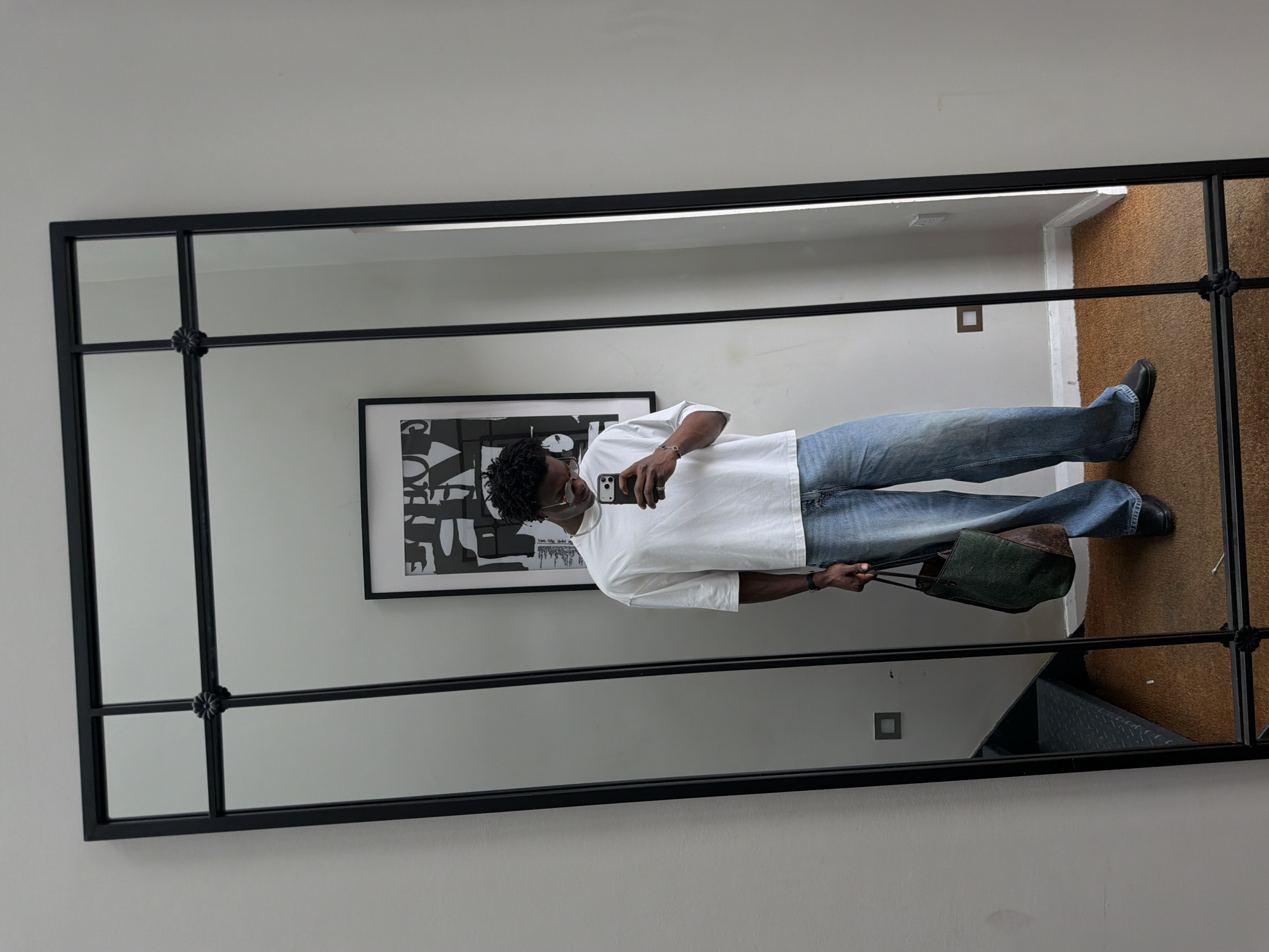 Man takes mirror selfie in London interior space