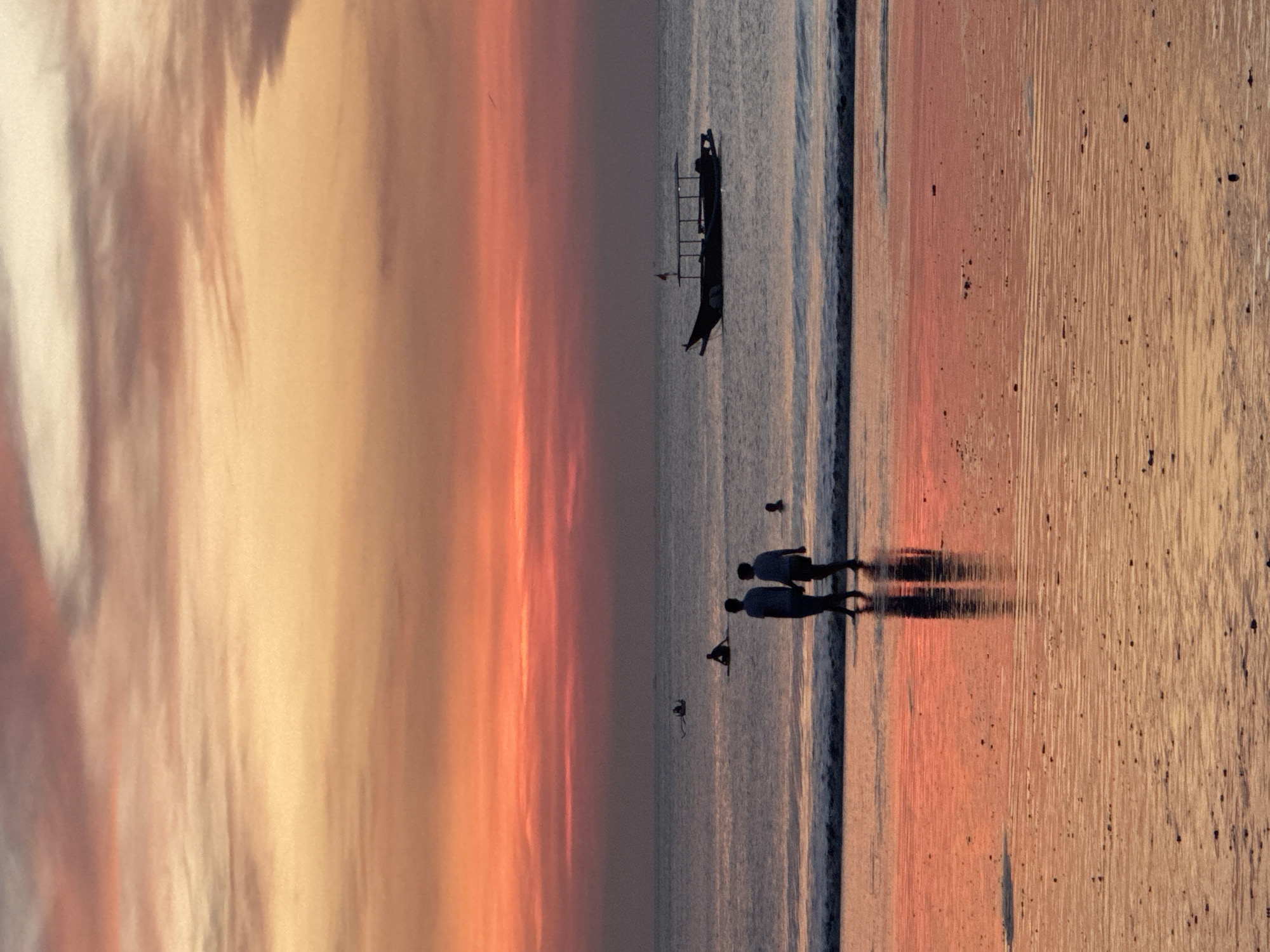 Sunset beach life unfolds in Kuta Selatan with horses and tourists