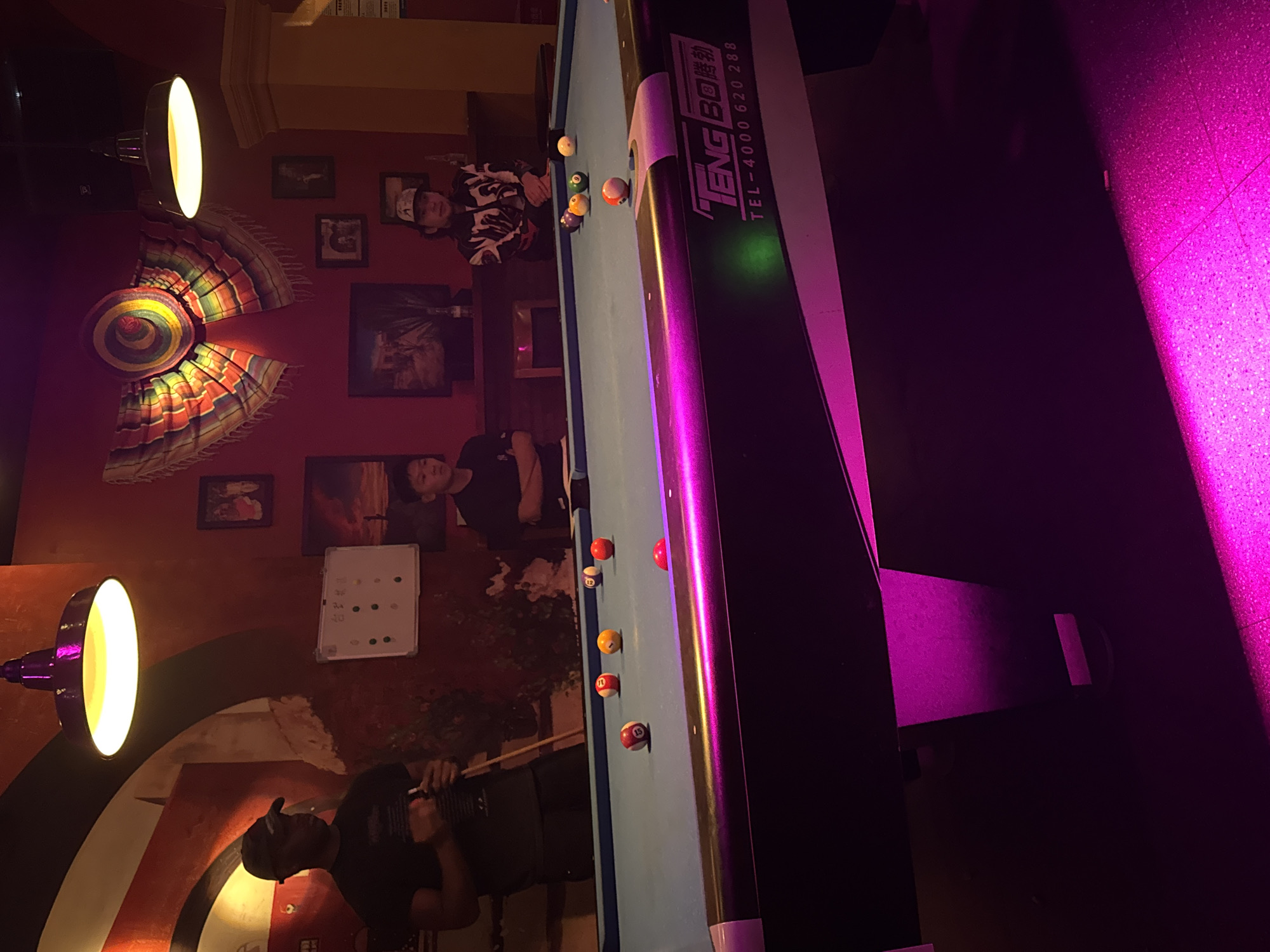 Man plays pool at decorated venue in Chenghua District