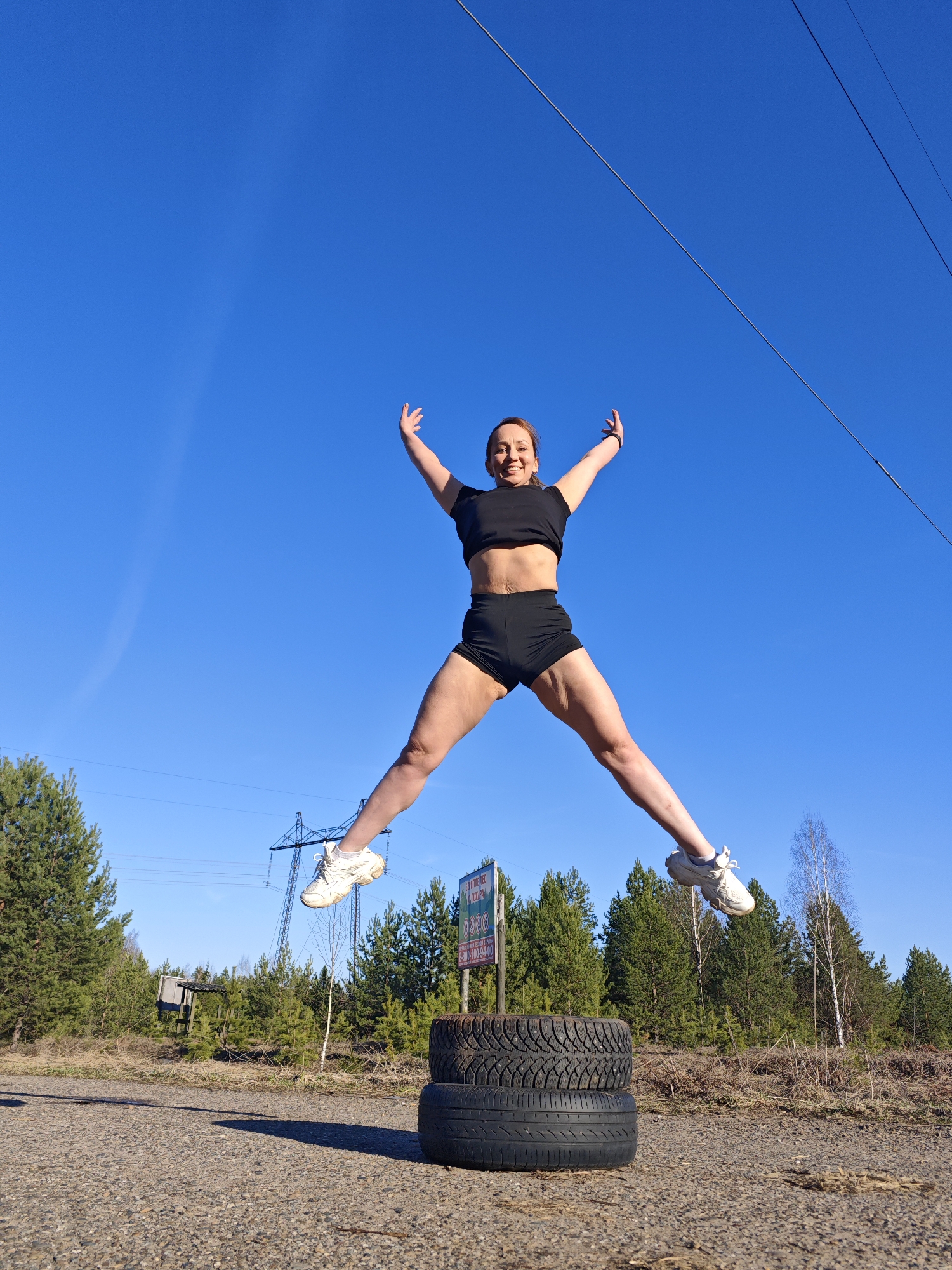 Woman performs tire workout routine in Chaikovsky, Russia