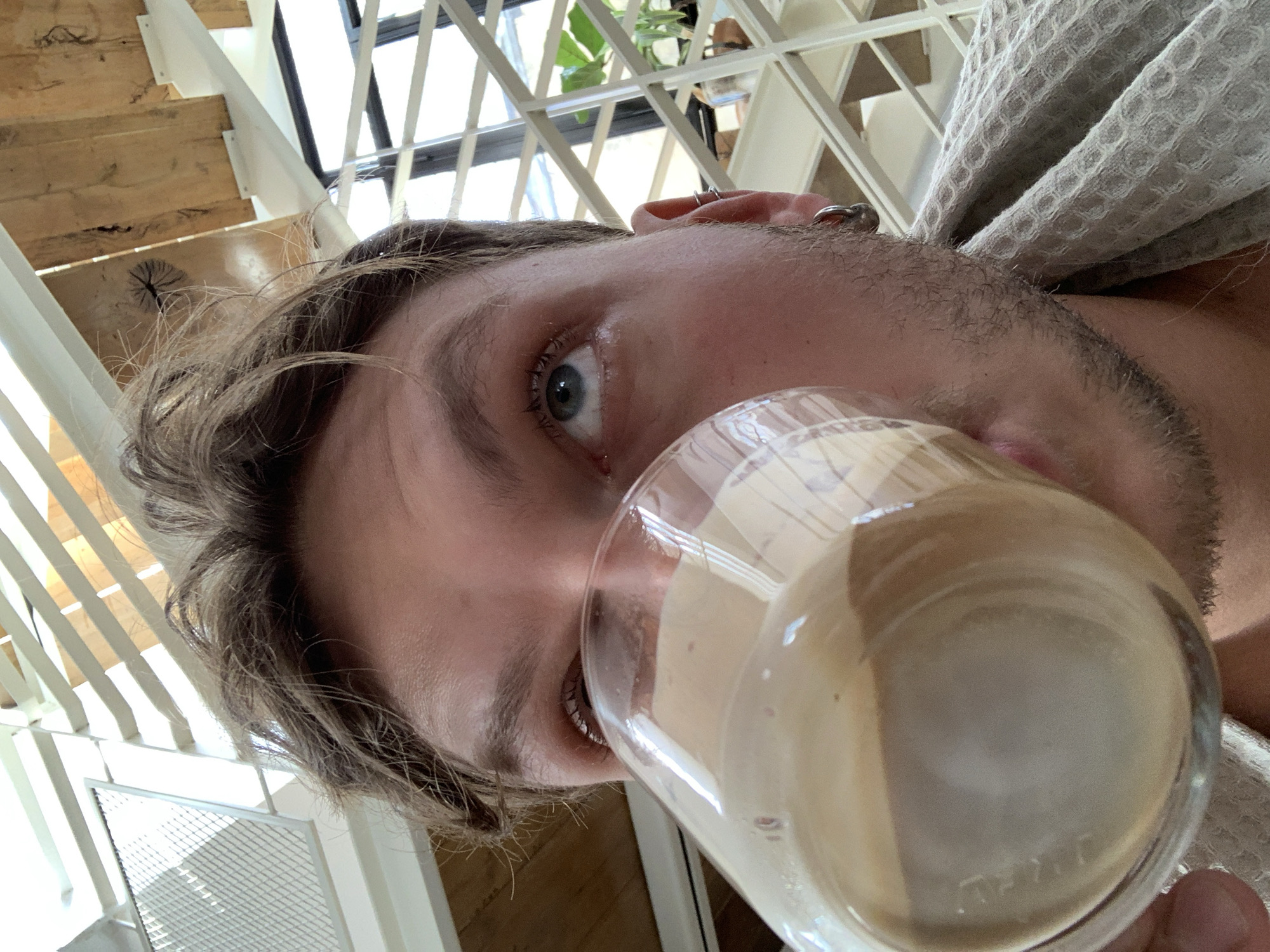 Man in robe drinks from glass in Tel Aviv