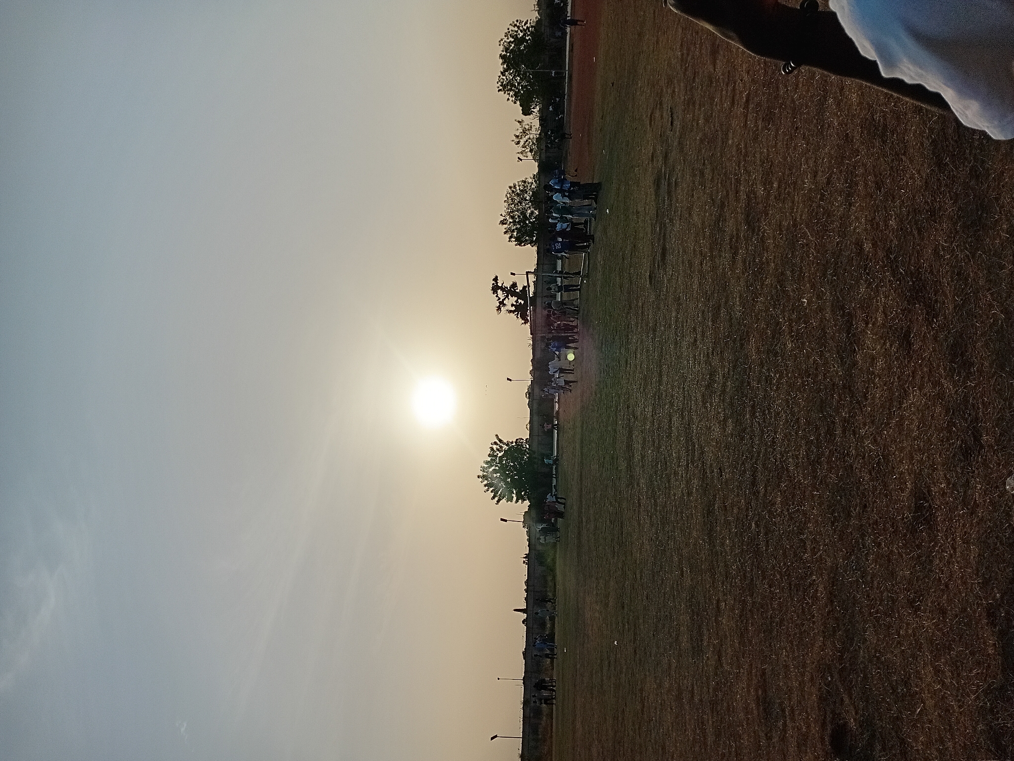 Group gathers in sunlit field in Dabawa, Nigeria