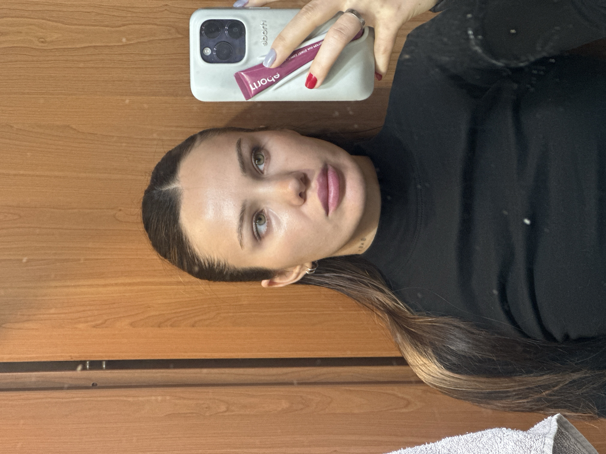 Woman displays iPhone and maroon tube in Belgrade