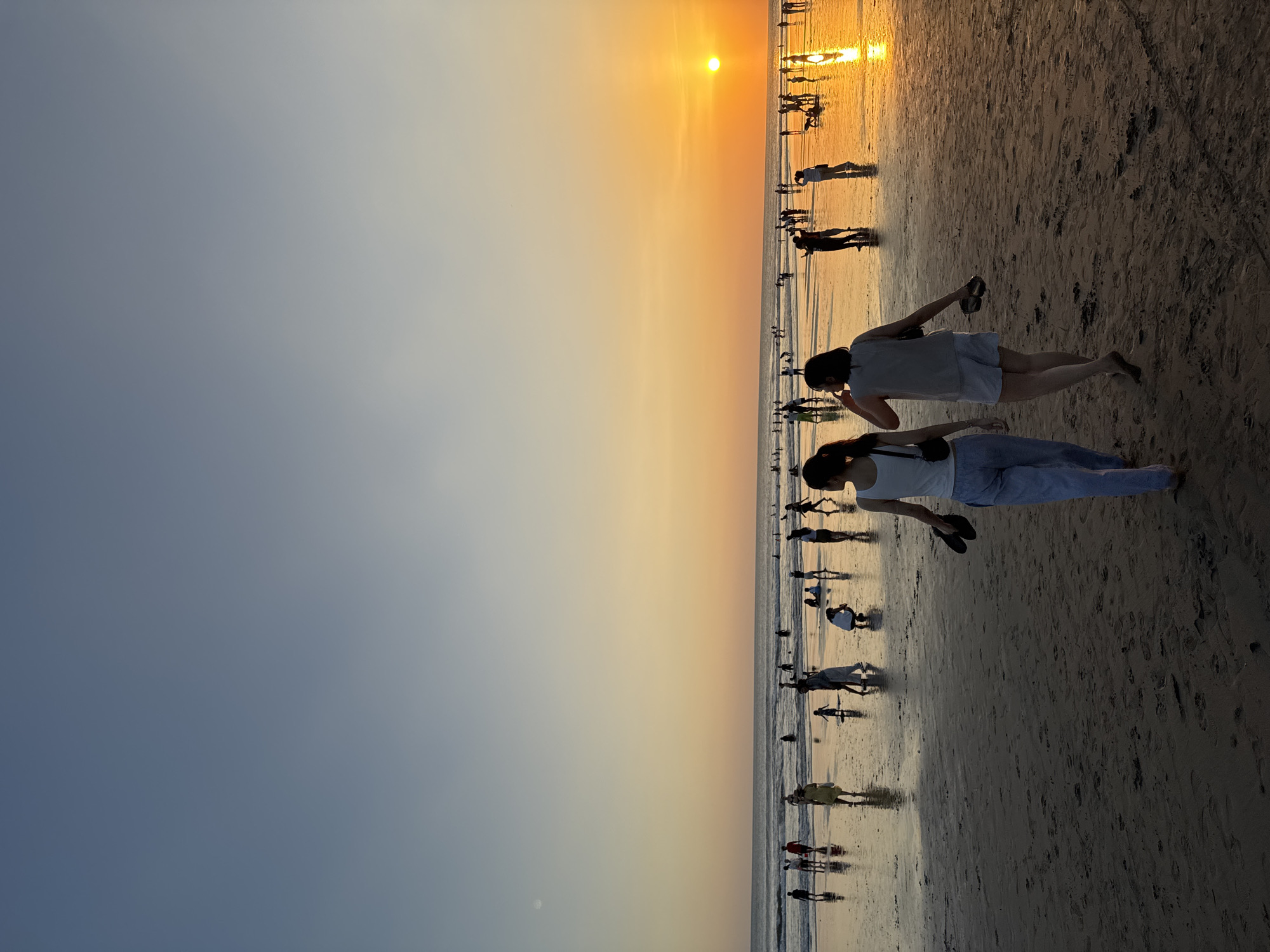Kuta Beach sunset crowd, street scenes, and shoreline activity
