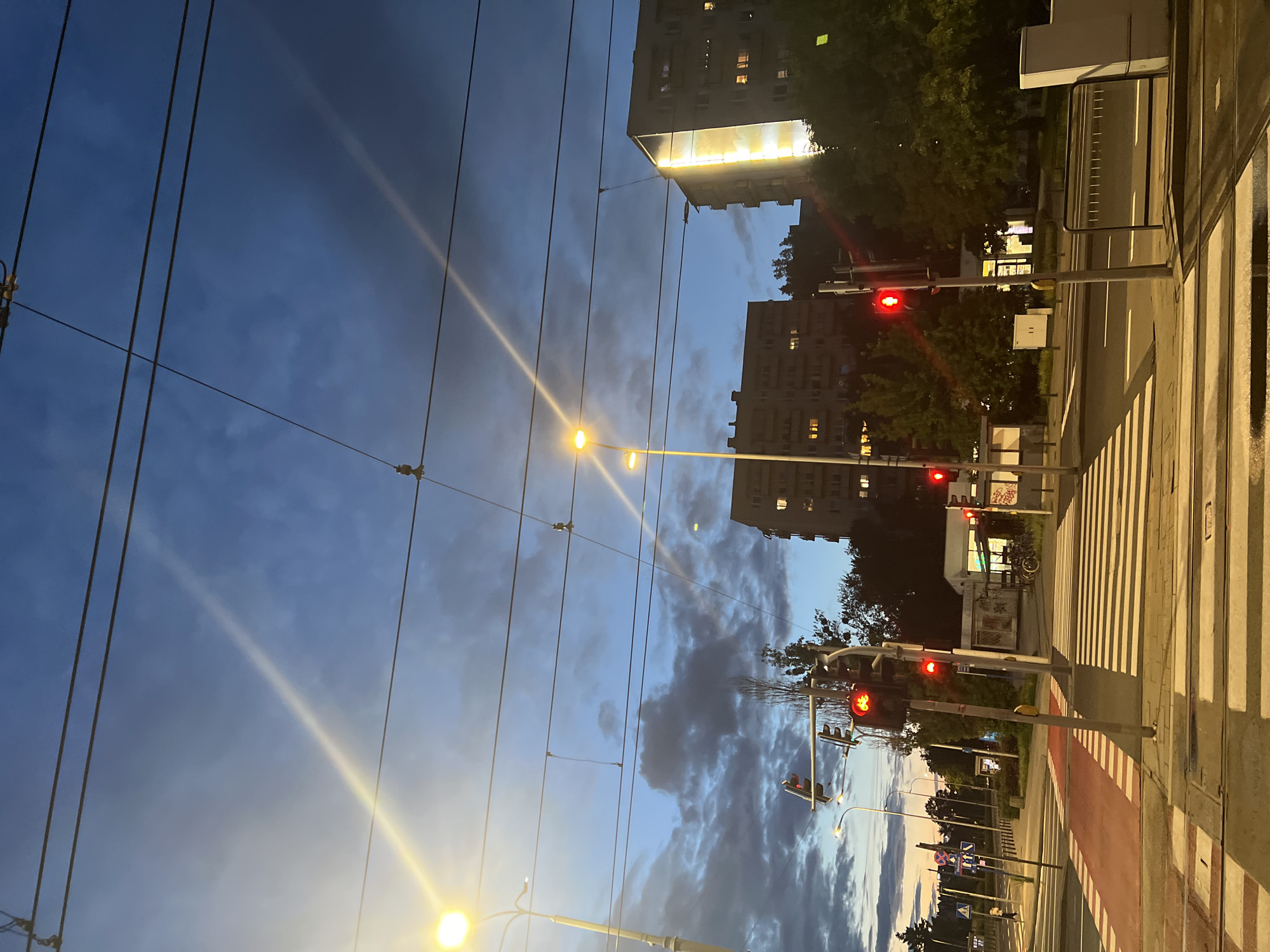 Dramatic dusk sky over Warsaw streets, July evening.