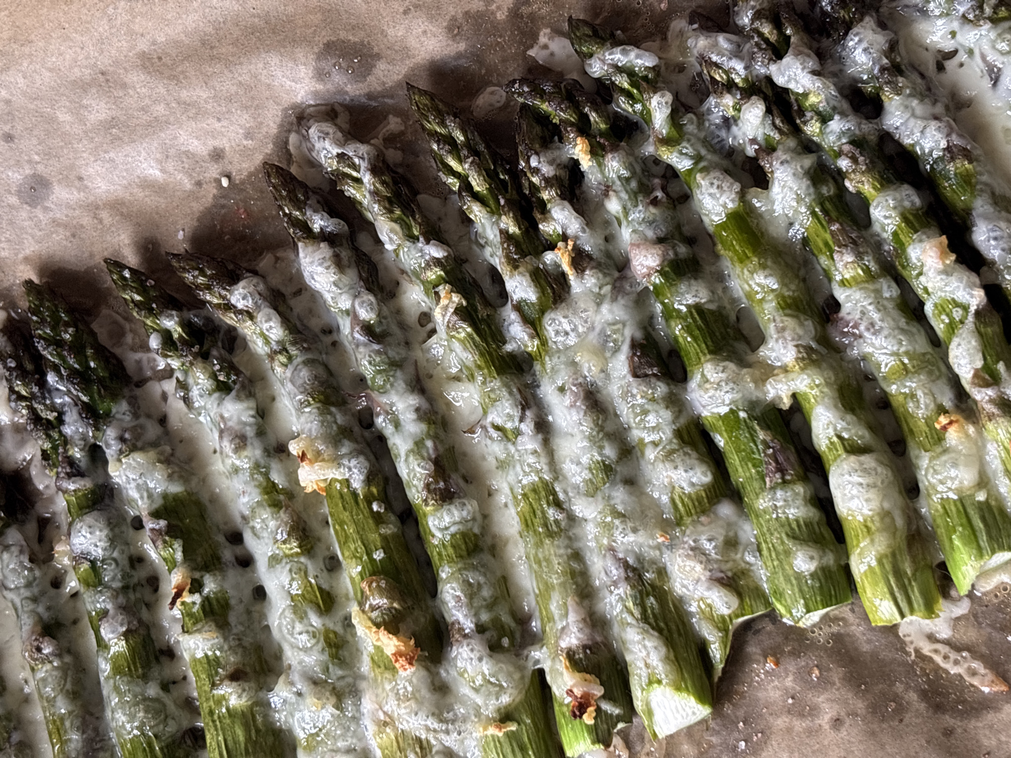 Baked asparagus with melted topping documented by witness