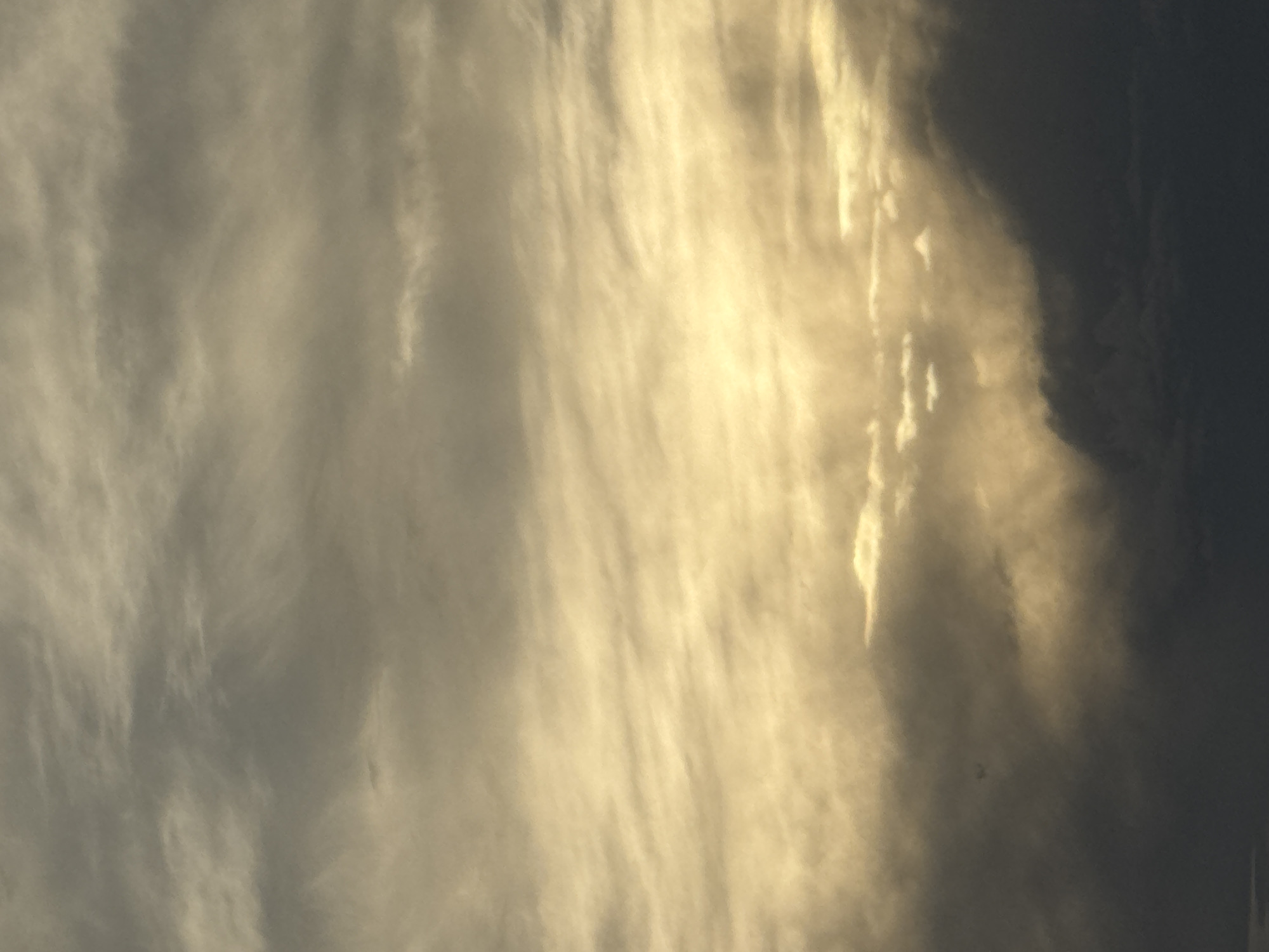 Golden light breaks over misty mountain ranges at dusk