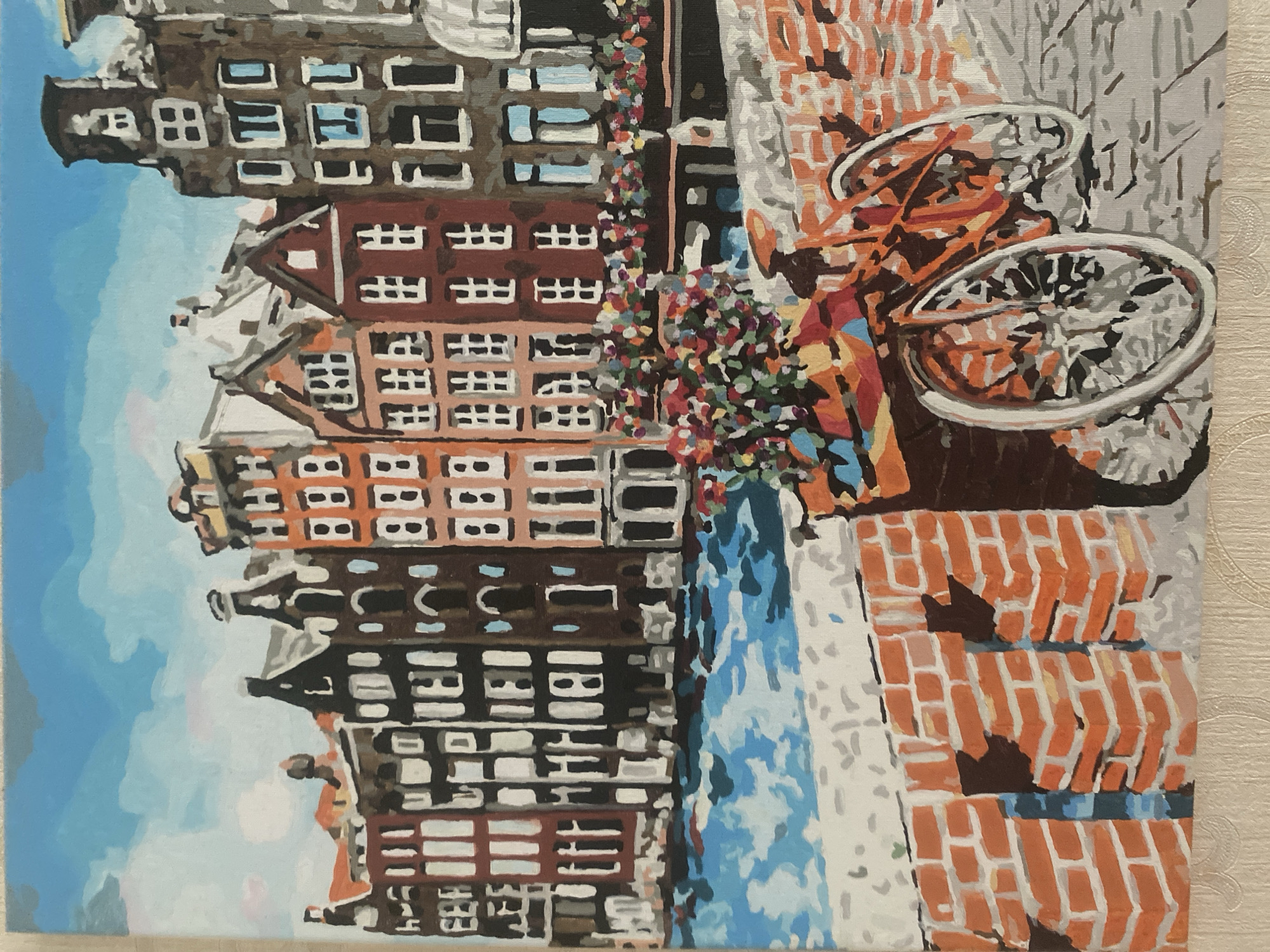 A mixed set of paintings: canals, cafés, flowers, and a dog