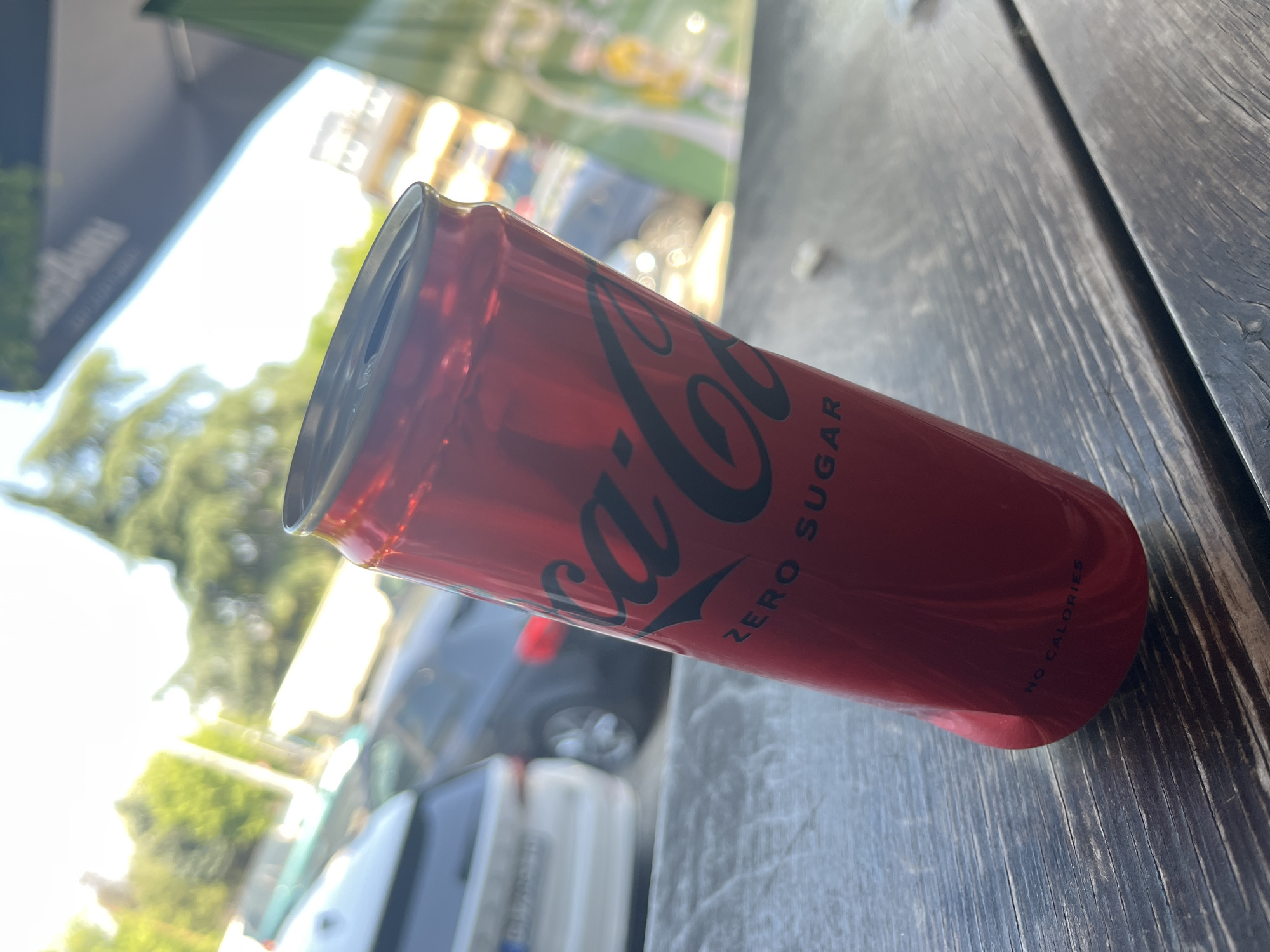 Everyday street scenes documented including beverage and parked cars