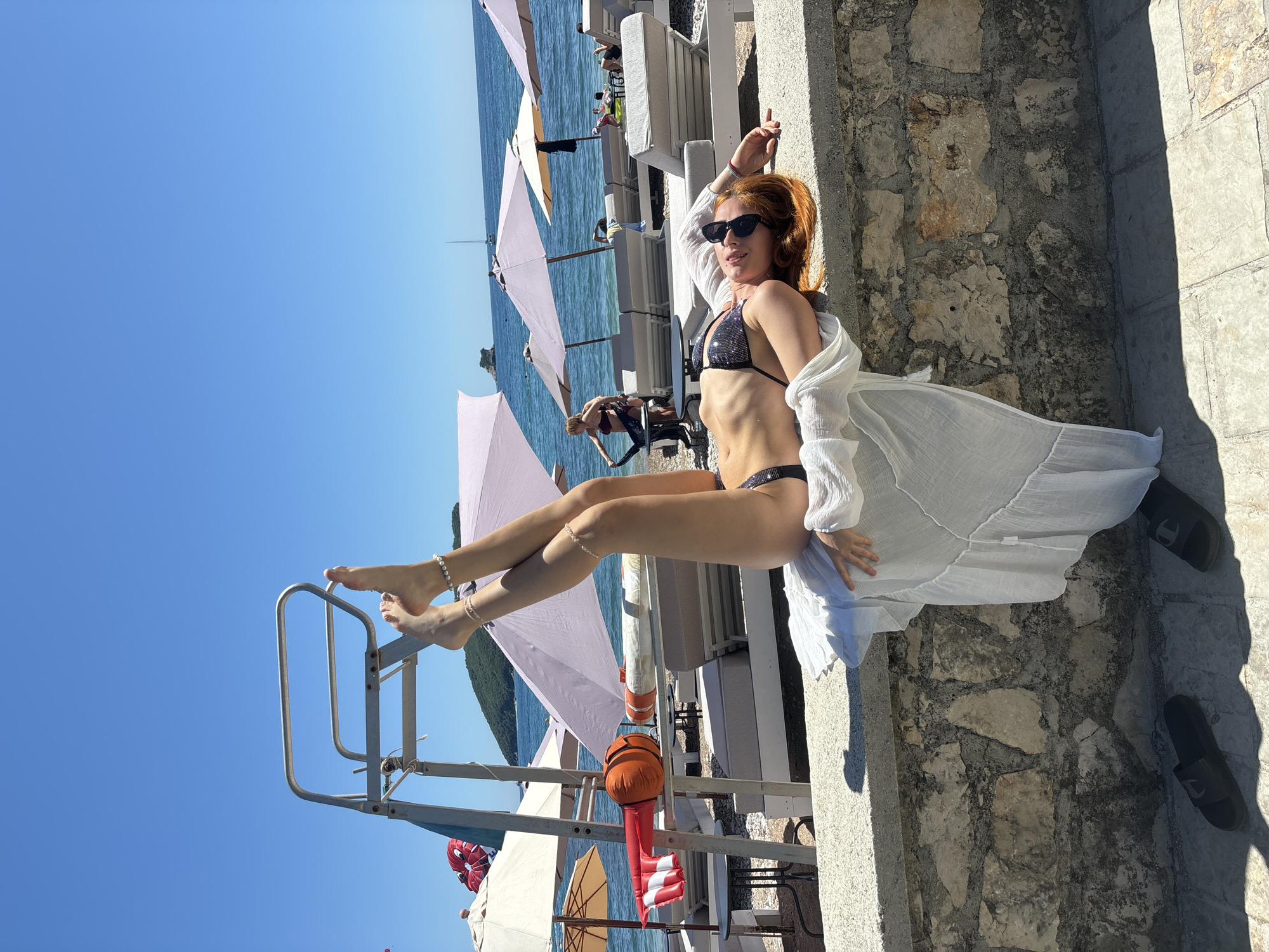 Woman poses for beach photos across Budva waterfront
